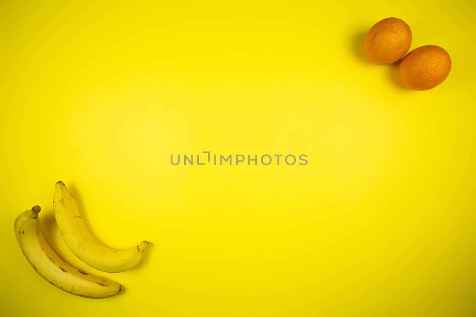 Fruit banana and orange on a yellow background, fruits