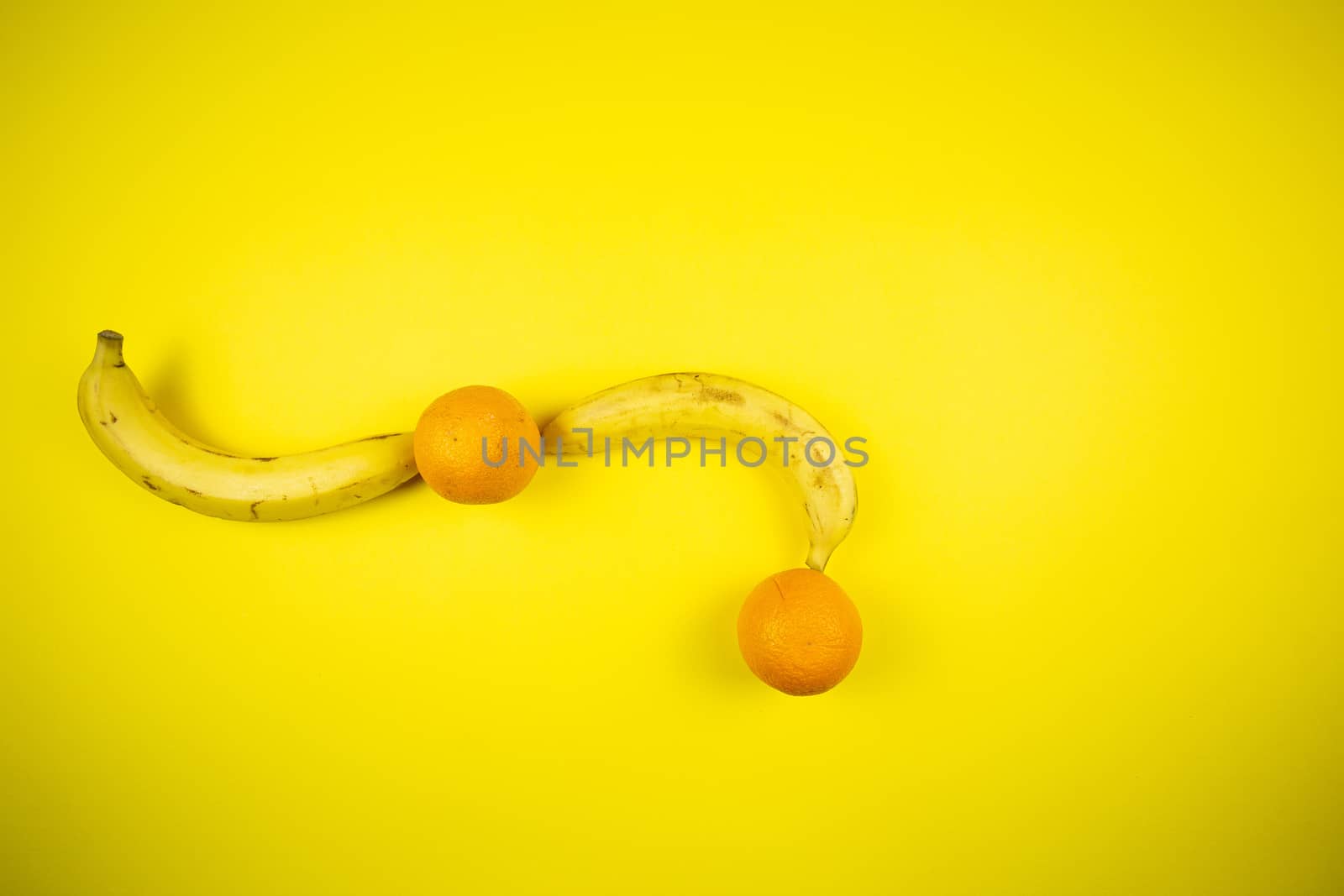 Fruit banana and orange on a yellow background, fruits