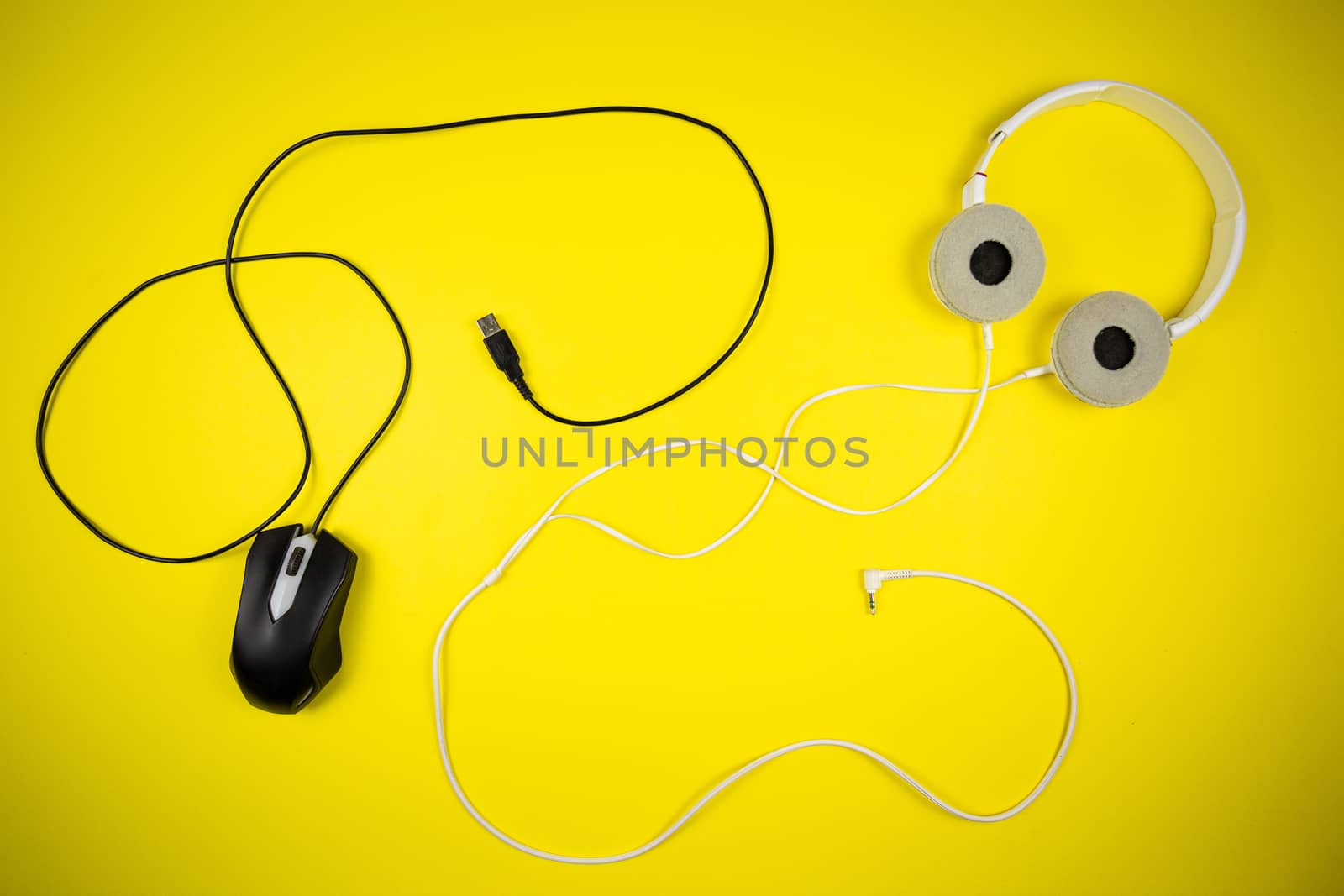 White headphones and a black computer mouse