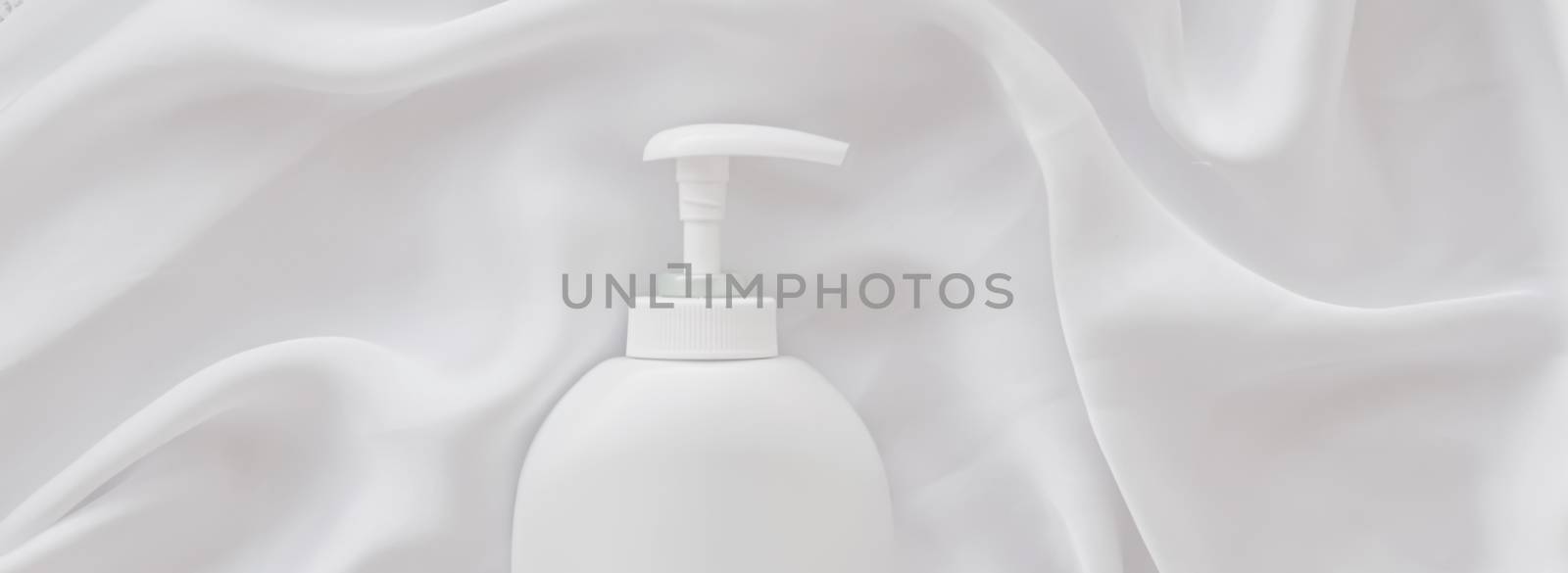 Blank label cosmetic container bottle as product mockup on white silk background, hygiene and healthcare