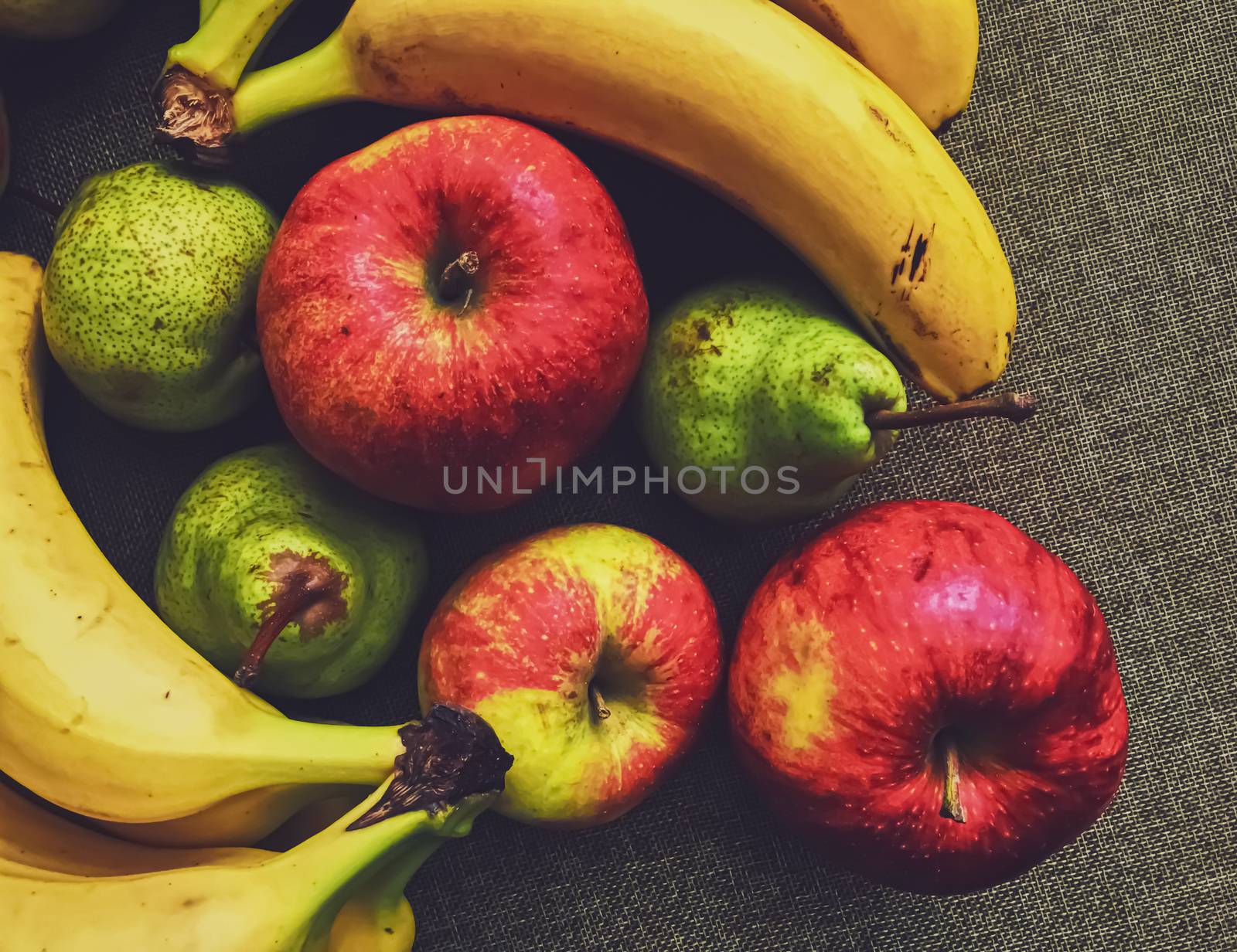 Organic apples, pears and bananas on rustic linen background, fruits farming and agriculture