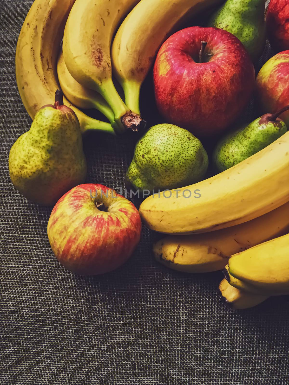 Organic apples, pears and bananas on rustic linen background by Anneleven