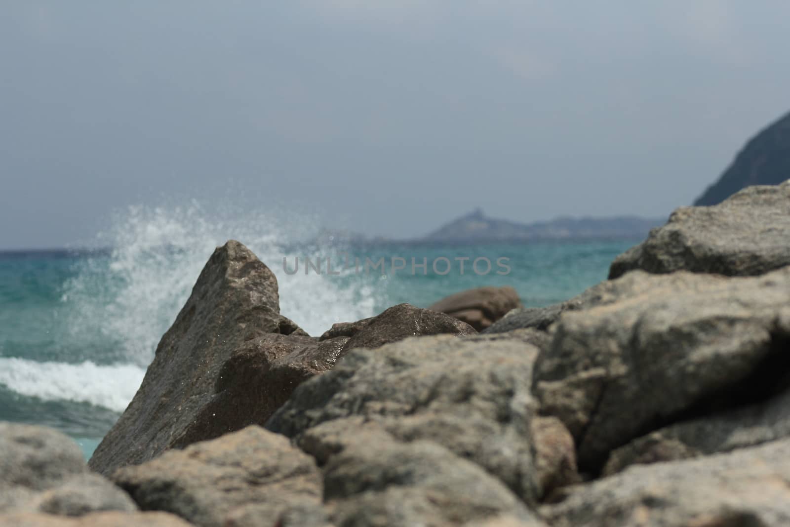 Sardinian rocky and natural beach landscape during a summer day