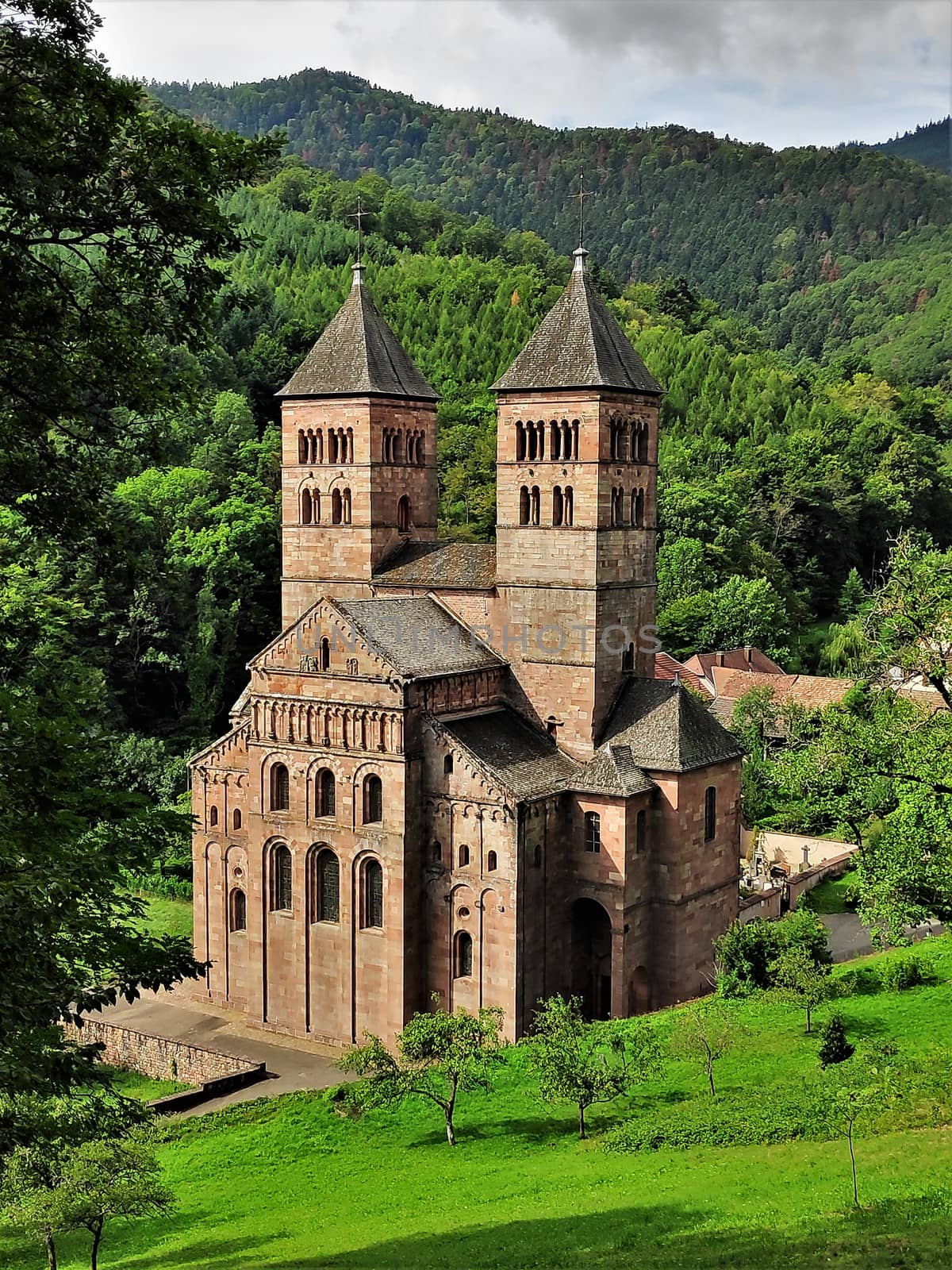 Murbach Abbey in the Alsace, France is located beautifully surrounded by green hills of the Vosges