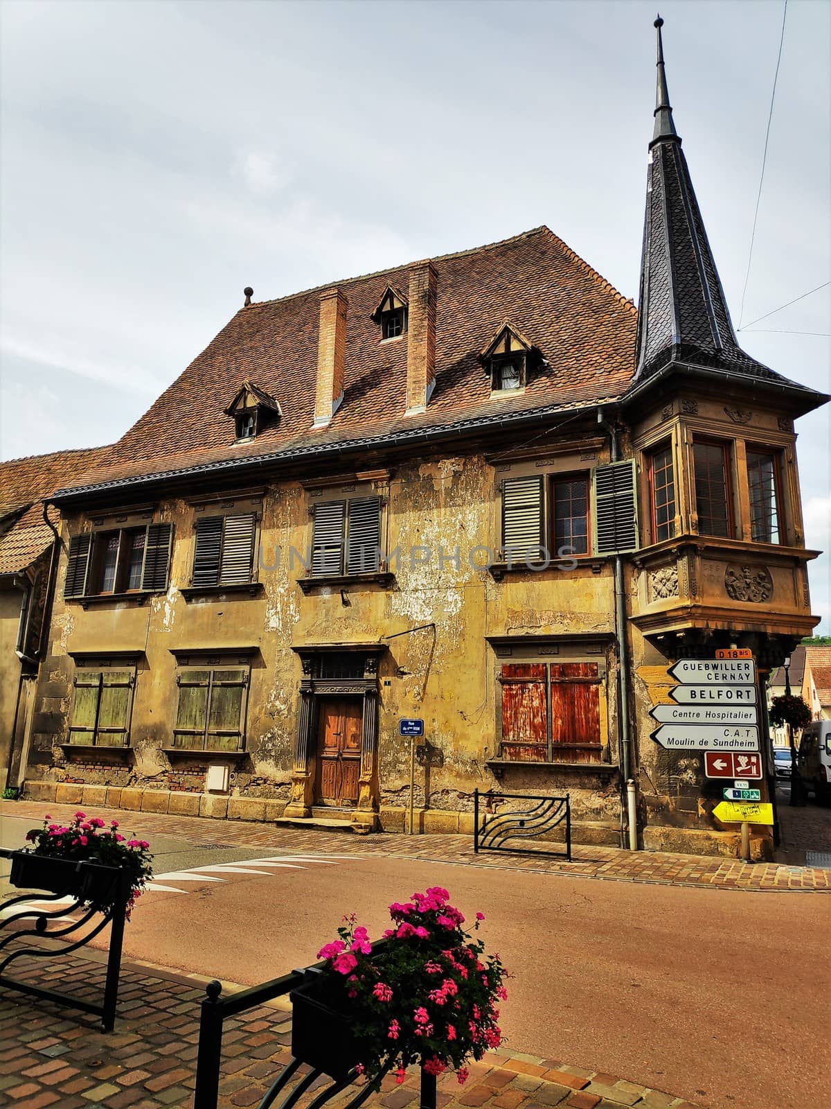 The main street in the Alsatian village Rouffach, France with different street signs