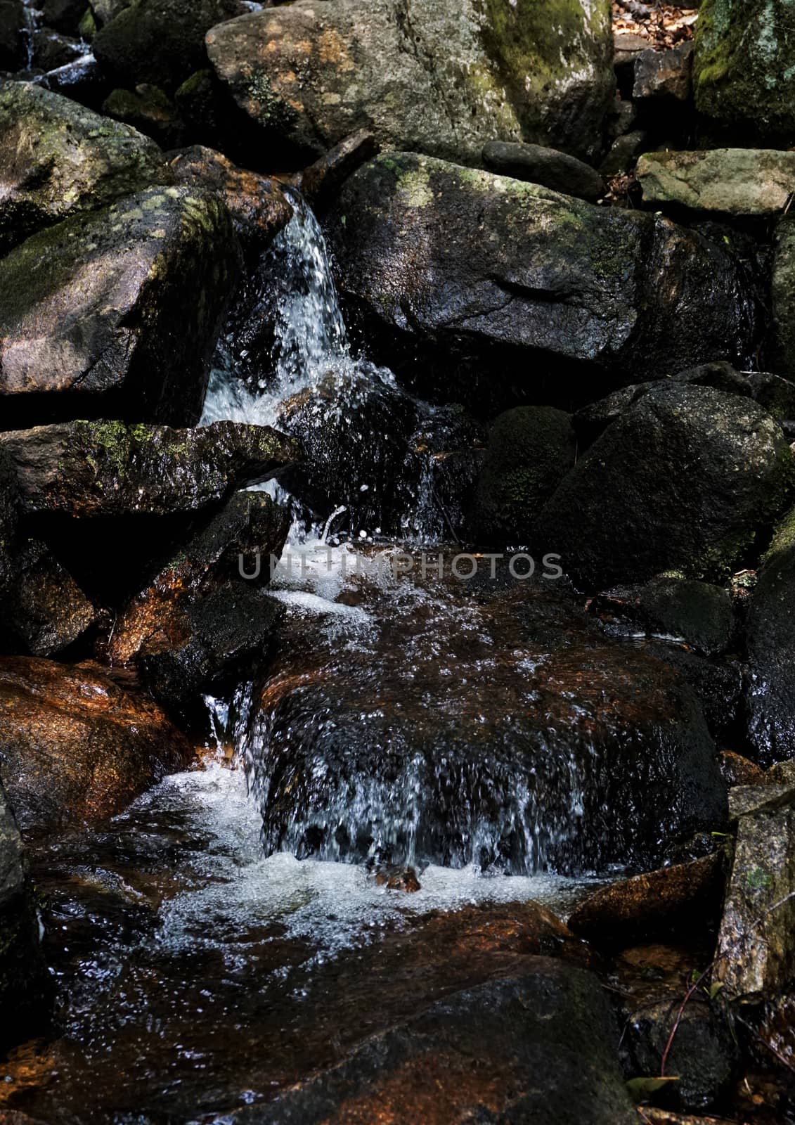 Close-up of rocks and a small waterfall by pisces2386