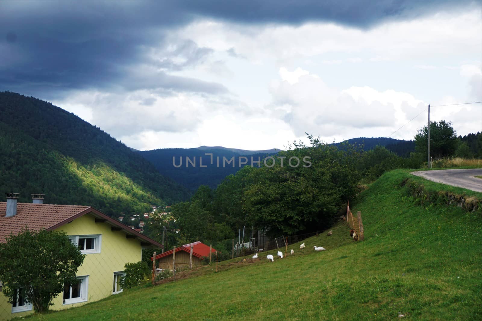 View over a house in the hills of La Bress to the Vosges mountain range by pisces2386