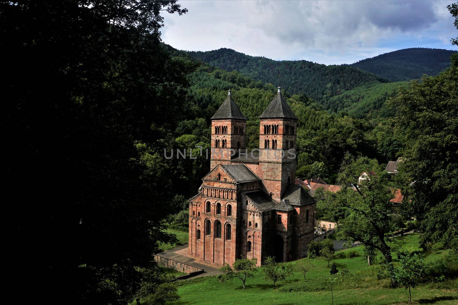 View on Murbach Abbey with green hills surrounding the building by pisces2386