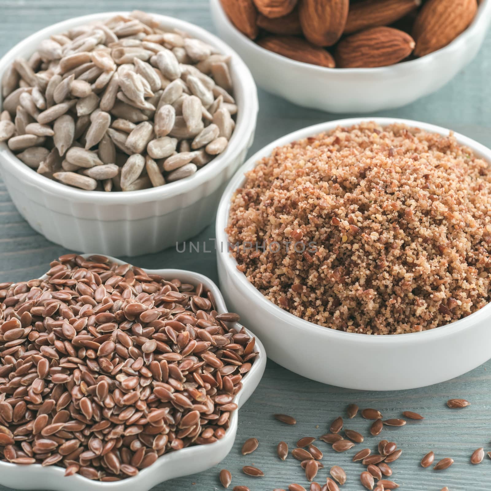 Homemade LSA mix in plate and Linseed or flax seeds, Sunflower seeds and Almonds. Traditional Australian blend of ground, source of dietary fiber, protein, omega fatty acids. Copy space for text.