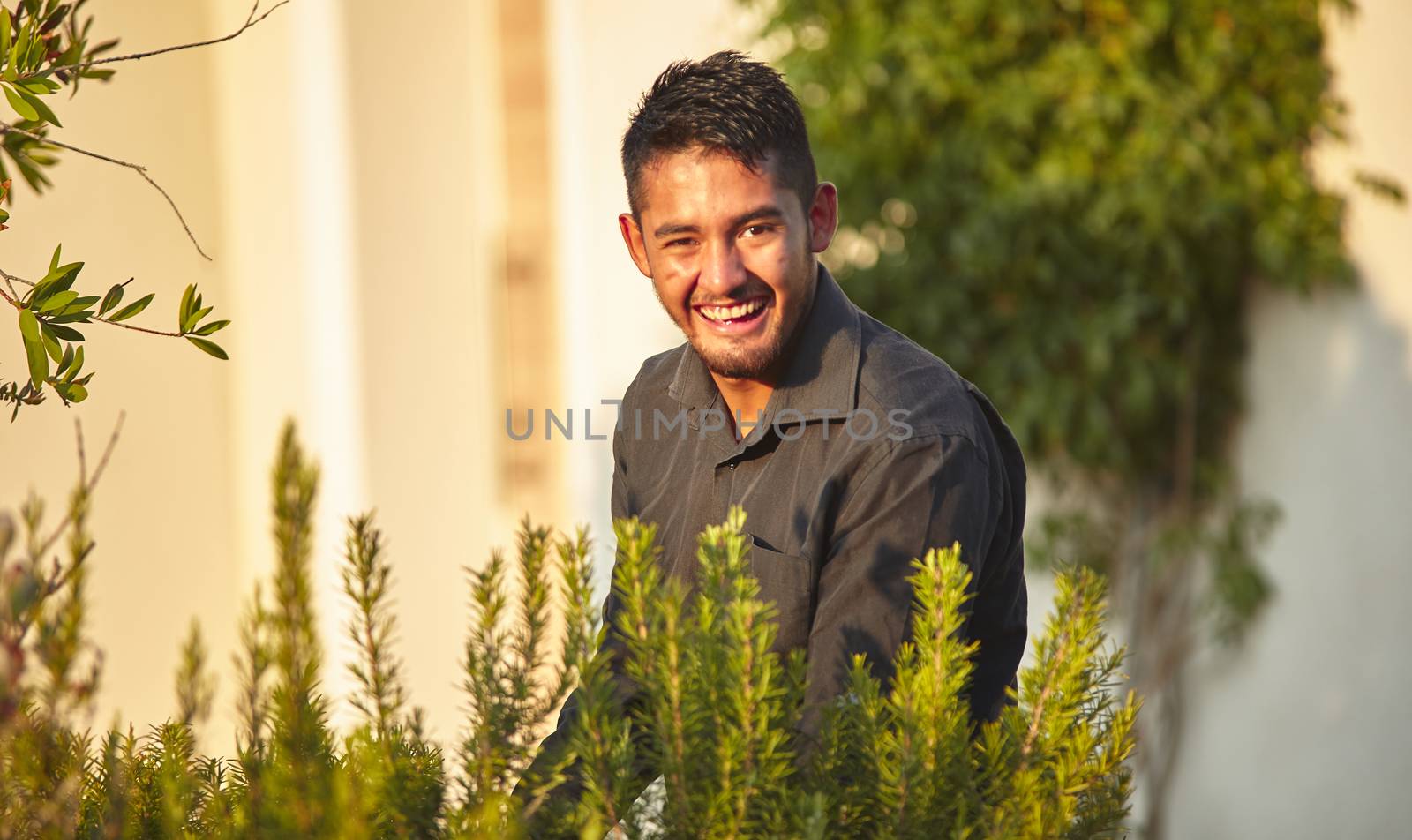 Portrait of a Mexican smiling boy immersed in nature at sunset