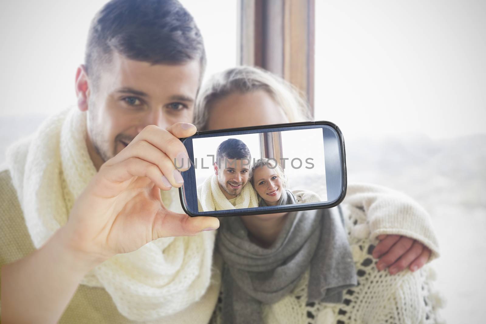 Couple taking selfie on smartphone by Wavebreakmedia