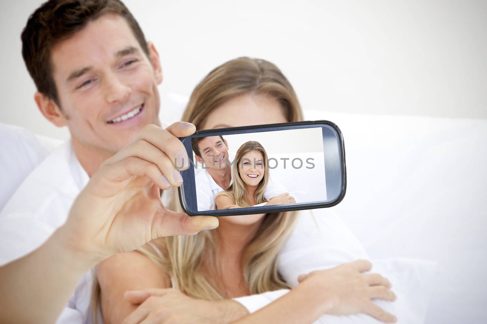 Composite of Couple taking selfie on smartphone