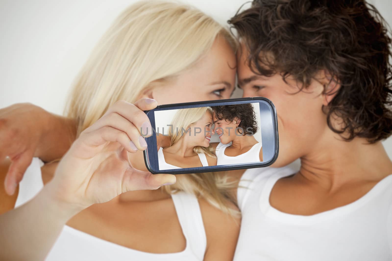 Couple taking selfie on smartphone by Wavebreakmedia