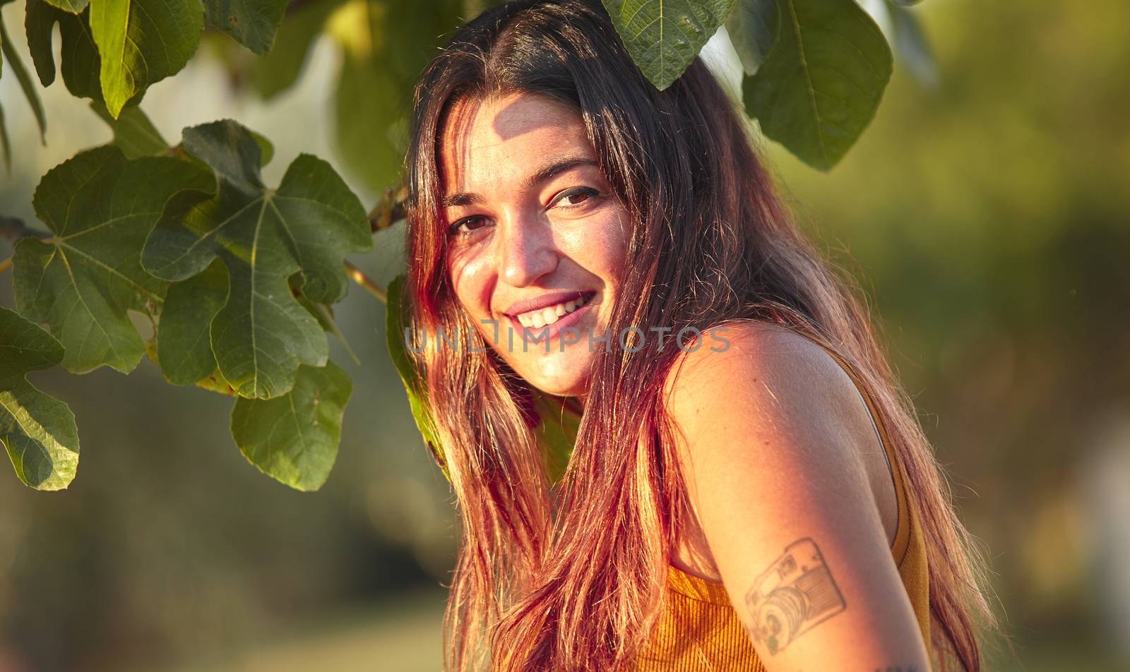 Girl with long dress in the middle of nature at sunset