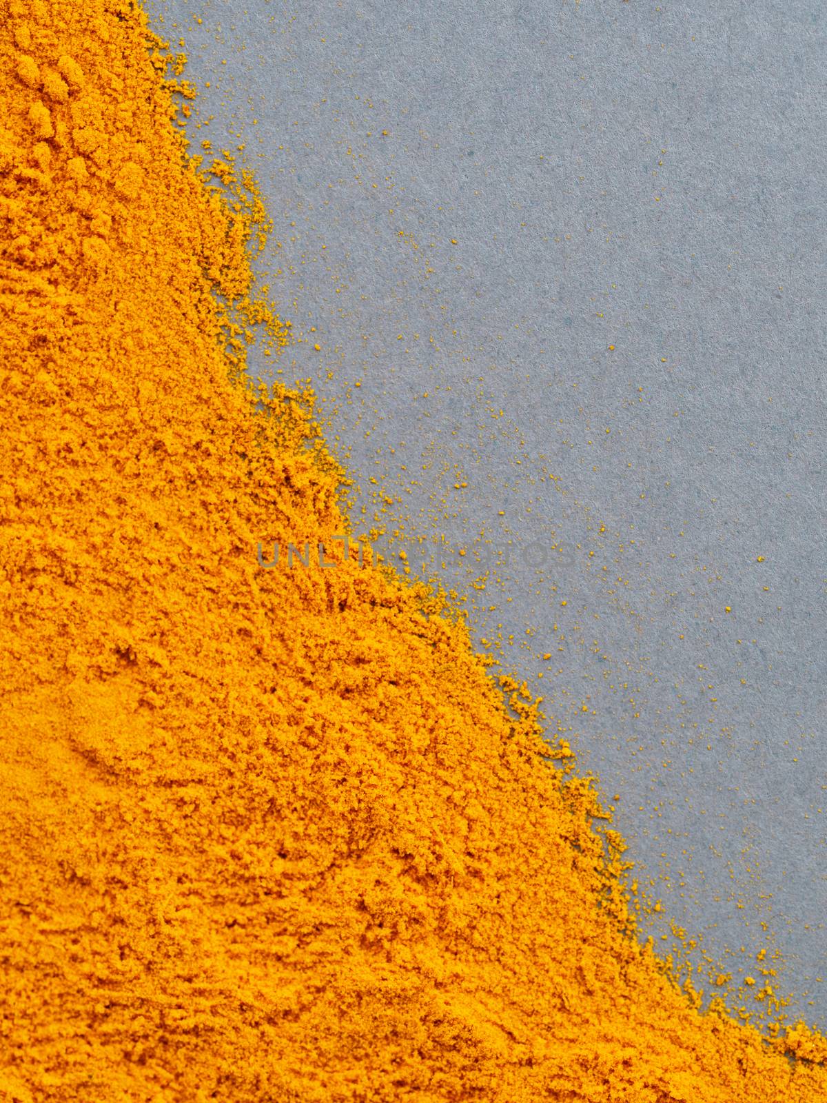 Turmeric Powder or Curcuma longa on gray background. Top view. Copy space for text.