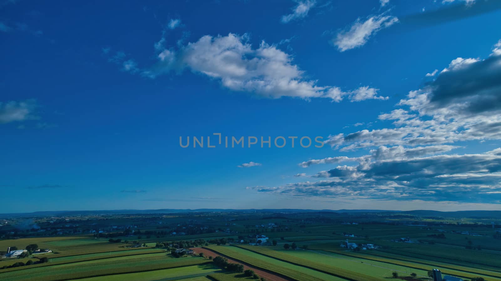 Blue sky and multiple clouds background showing a horizon