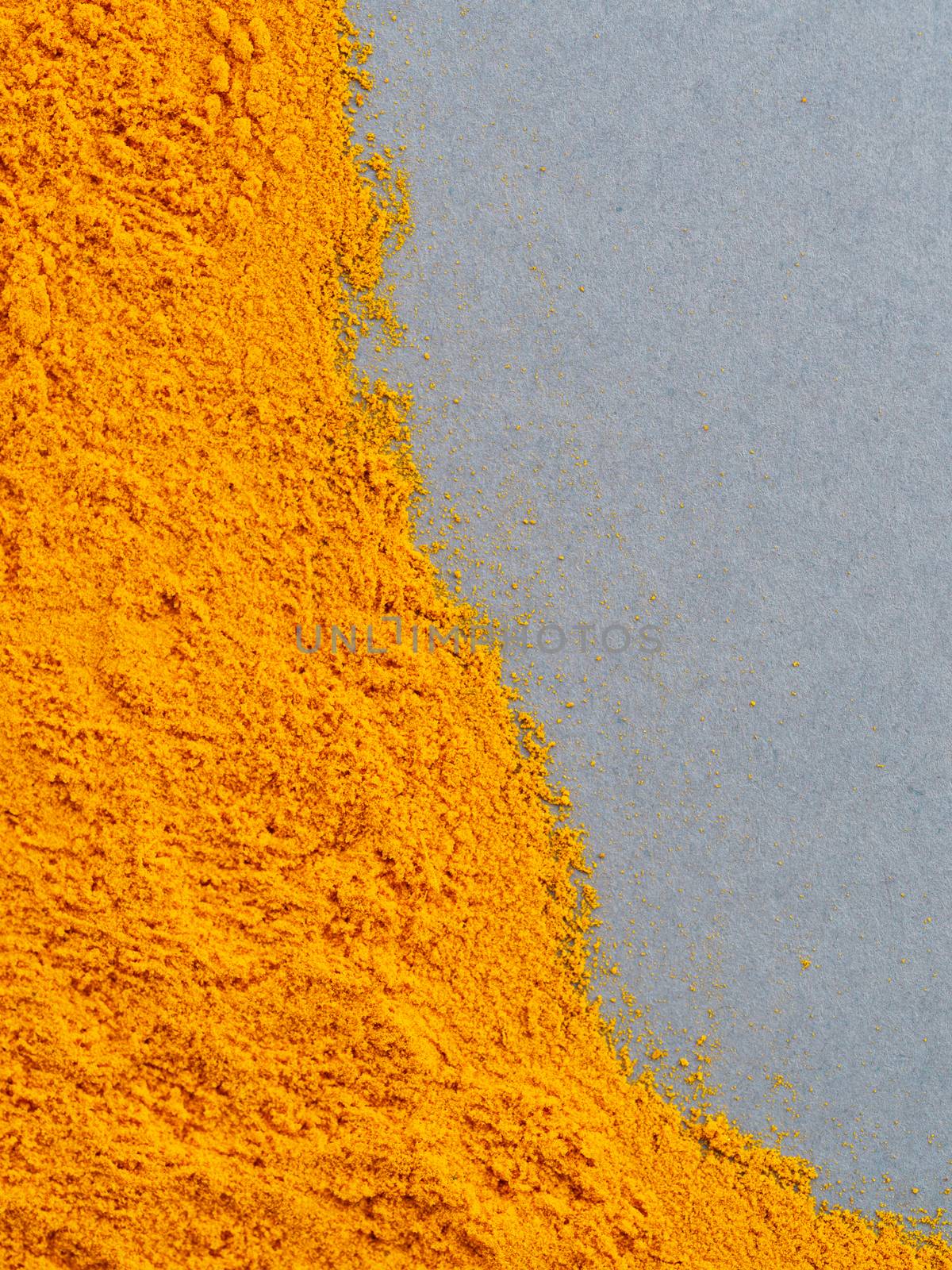 Turmeric Powder or Curcuma longa on gray background. Top view. Copy space for text.