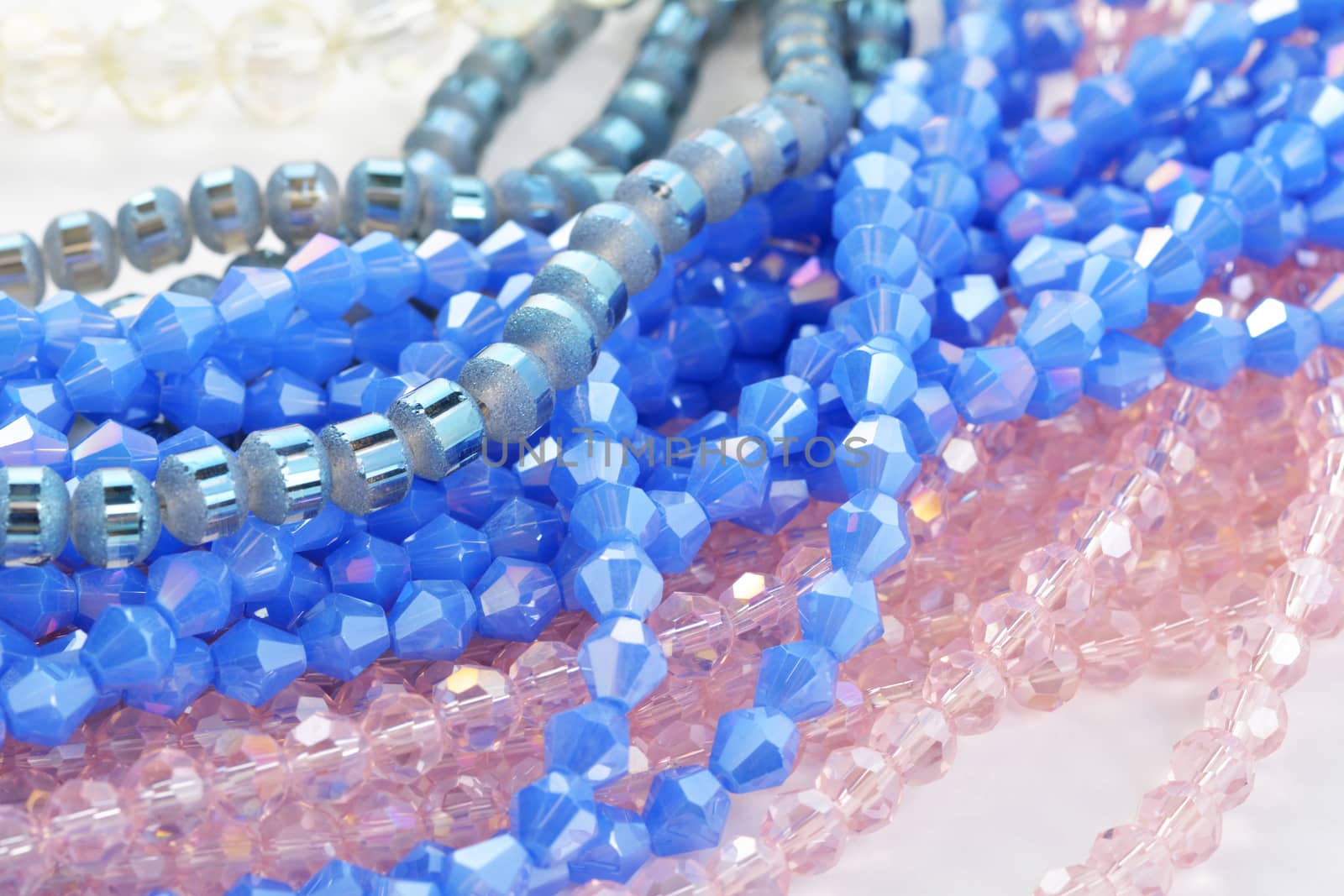 Mix of color faceted glass sparkle beads. Materials for creative work on white background.