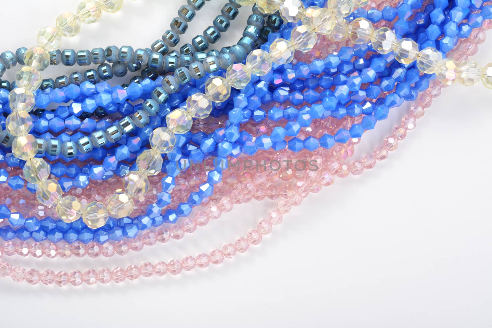 Color faceted glass sparkle beads. Materials for creative work on white background. by polyats