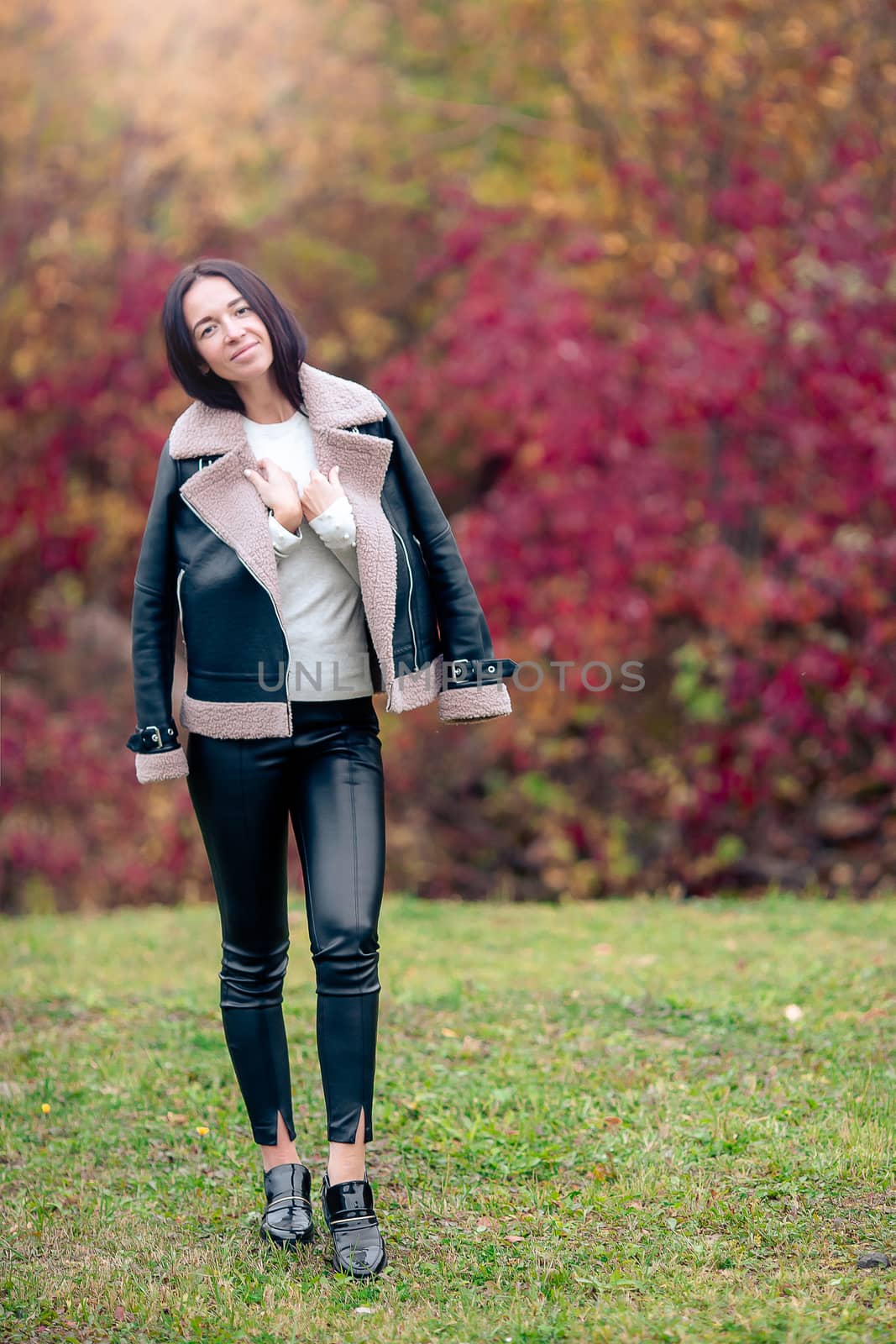 Beautiful girl in autumn park outdoors on sunny day by travnikovstudio