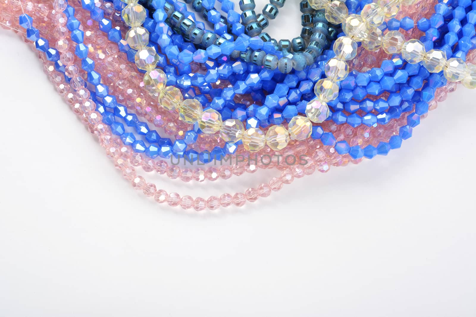 Color faceted glass sparkle beads. Materials for creative work on white background. by polyats