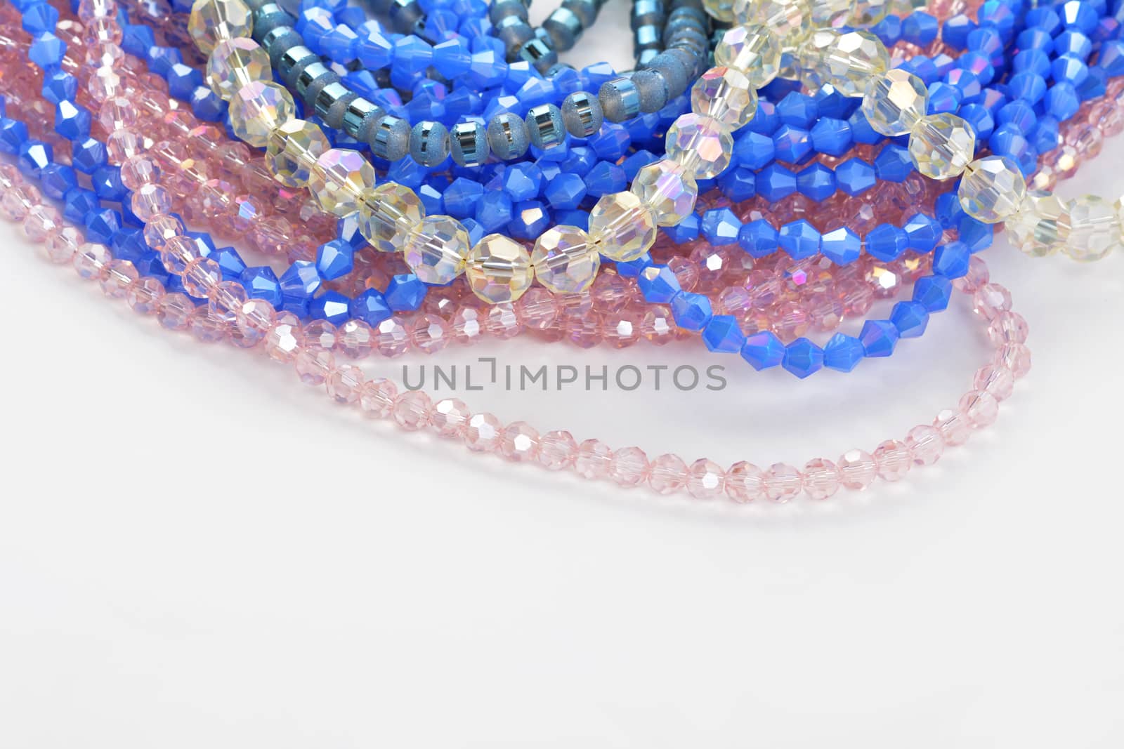 Mix of color faceted glass sparkle beads. Materials for creative work on white background.