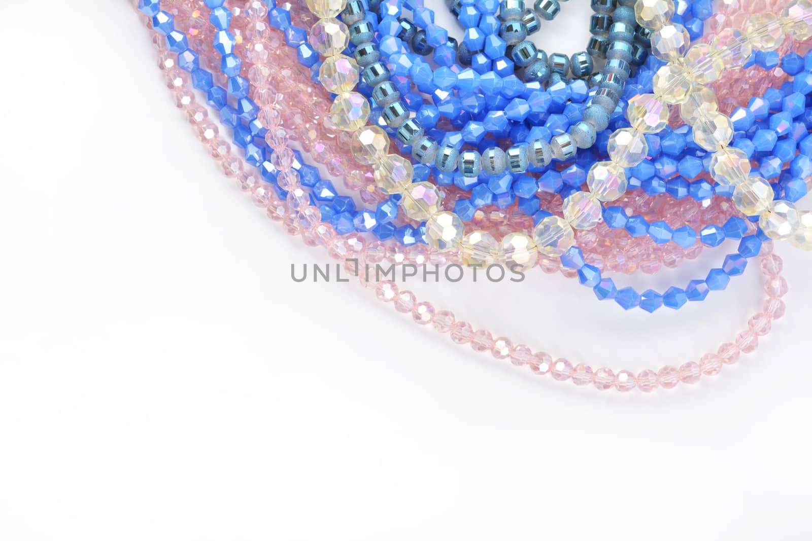 Color faceted glass sparkle beads. Materials for creative work on white background. by polyats