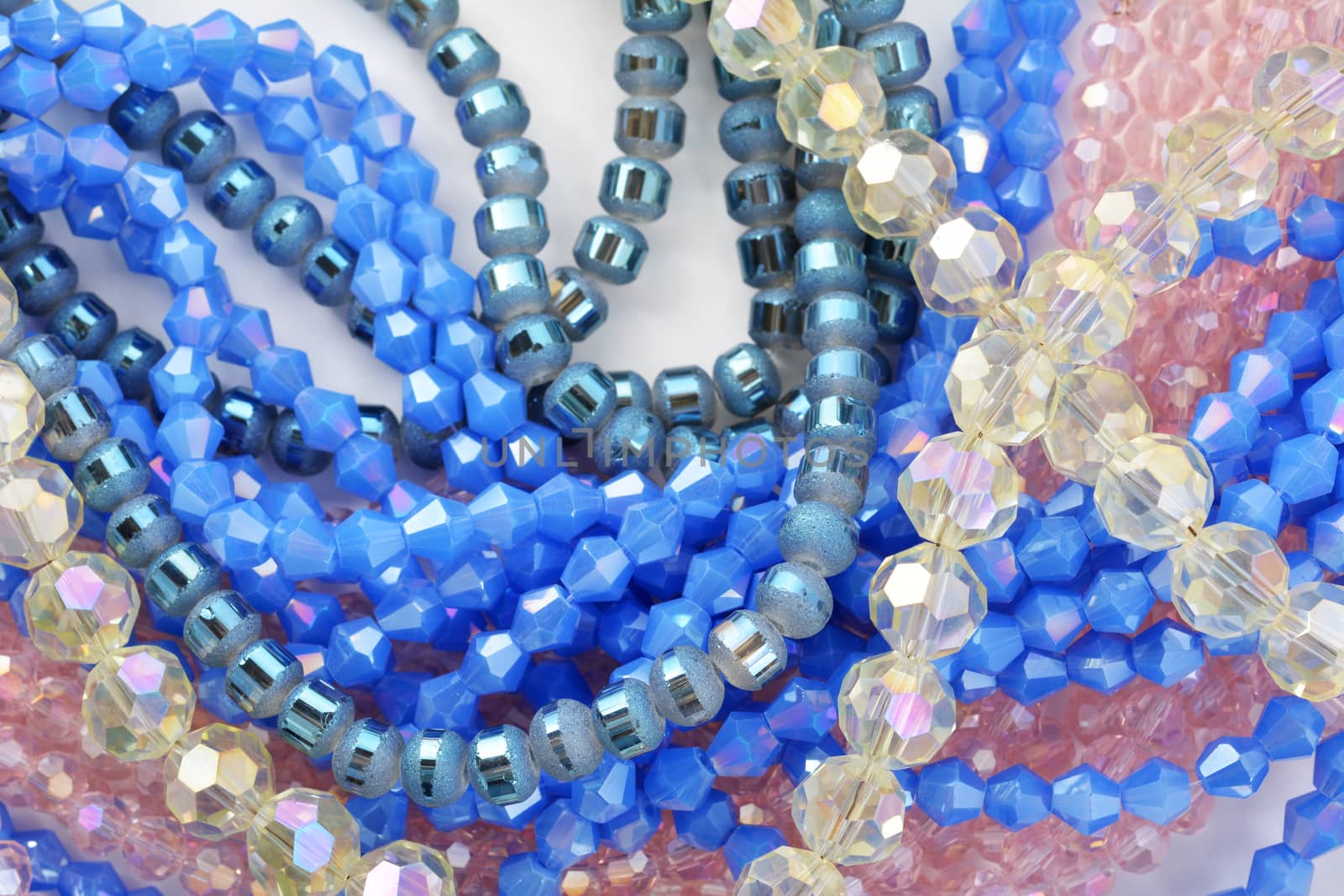 Mix of color faceted glass sparkle beads. Materials for creative work on white background.