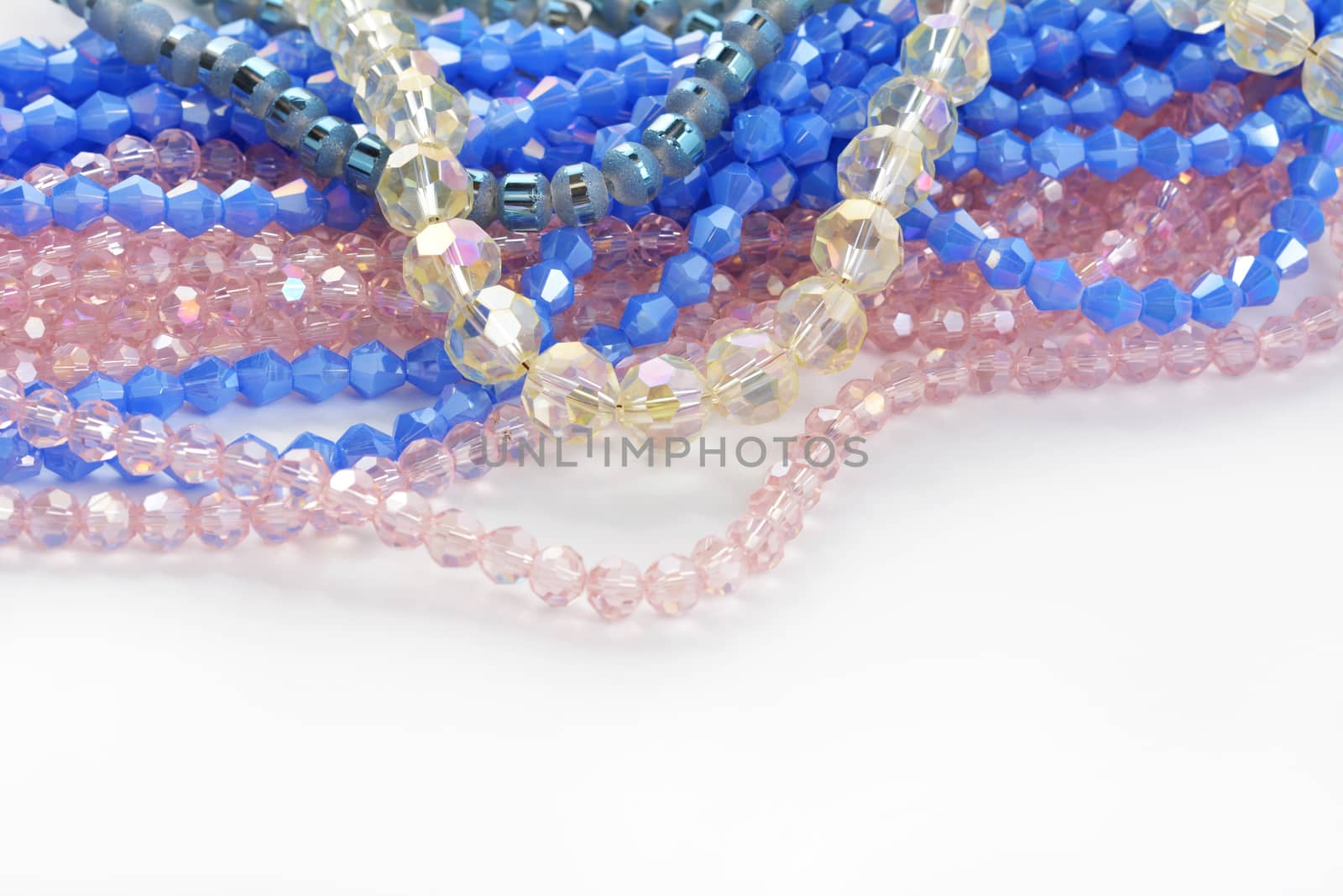 Mix of color faceted glass sparkle beads. Materials for creative work on white background.