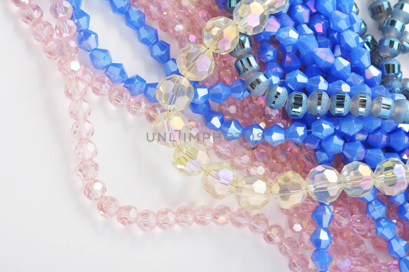 Mix of color faceted glass sparkle beads. Materials for creative work on white background.