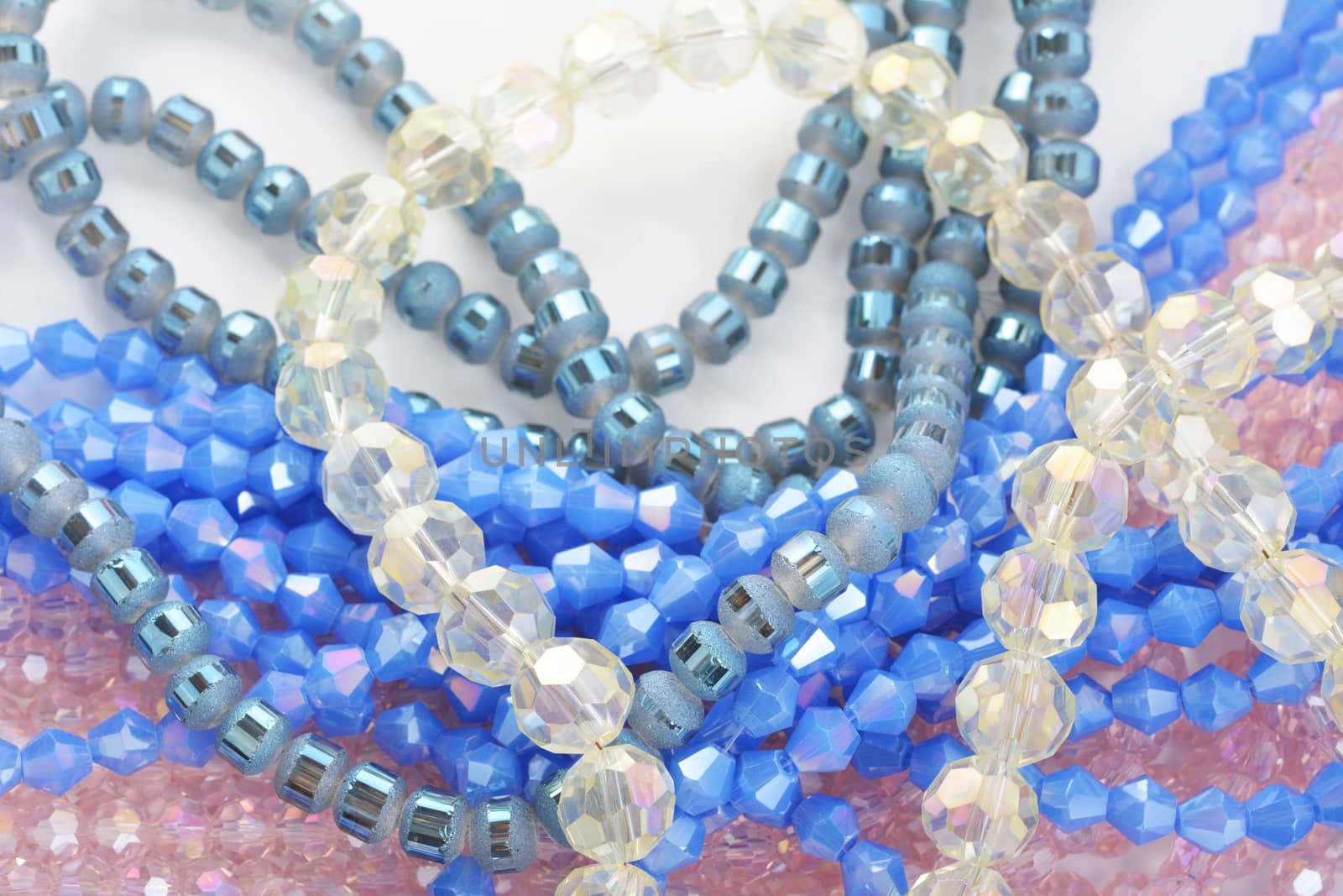 Mix of color faceted glass sparkle beads. Materials for creative work on white background.