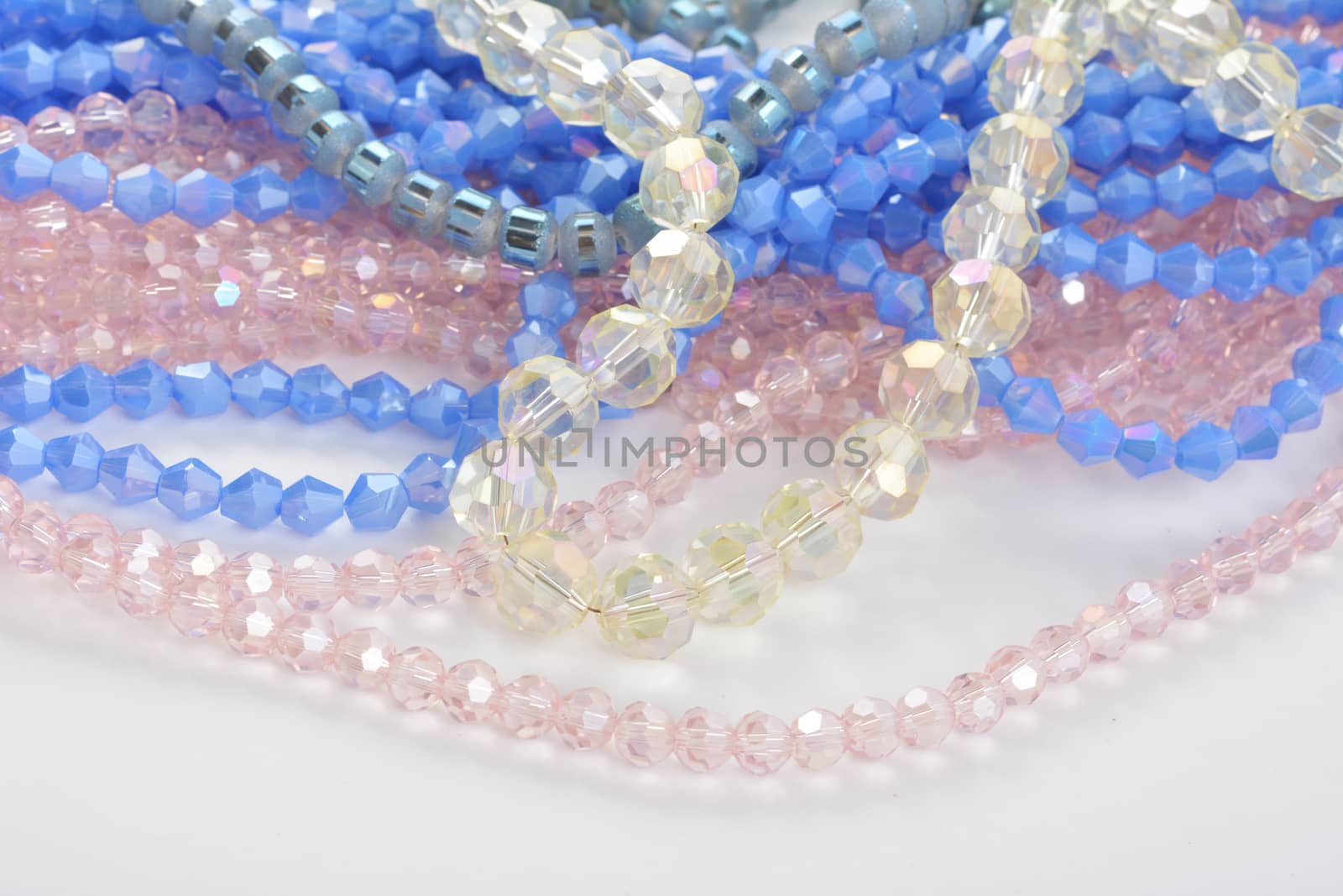 Mix of color faceted glass sparkle beads. Materials for creative work on white background.