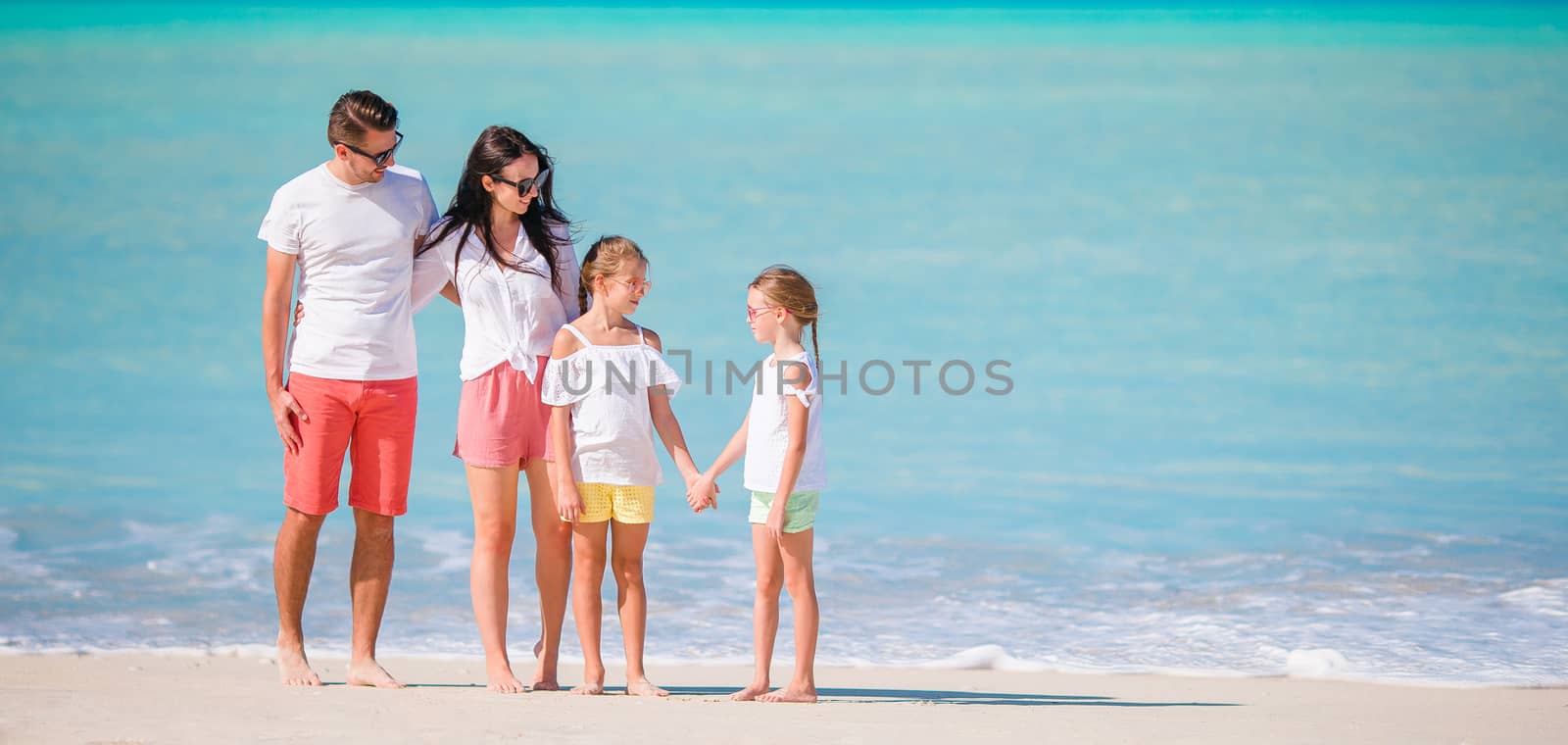 Panorama of family on beach holiday by travnikovstudio