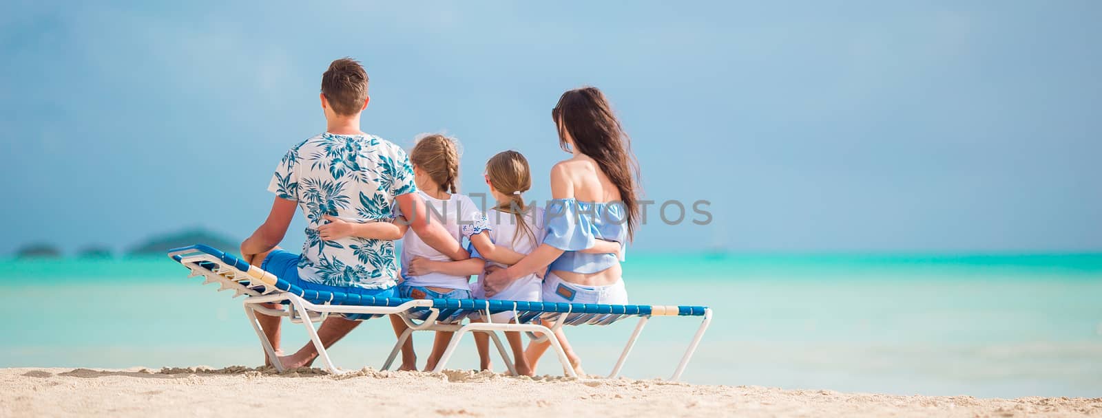 Happy beautiful family on the beach by travnikovstudio