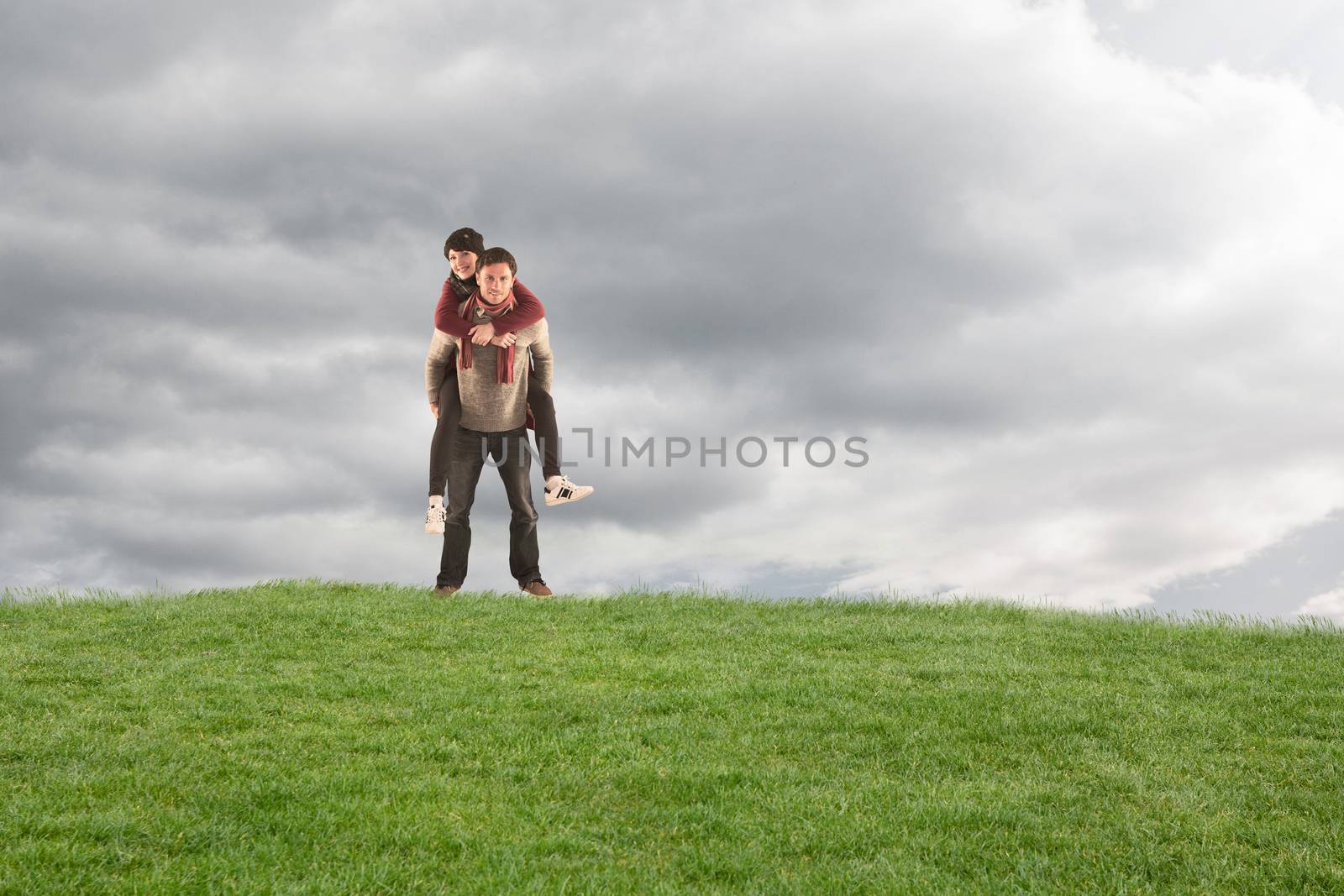 Composite image of man giving girlfriend piggy back by Wavebreakmedia