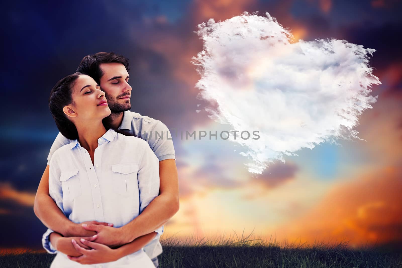 Cute couple embracing with eyes closed against cloud heart
