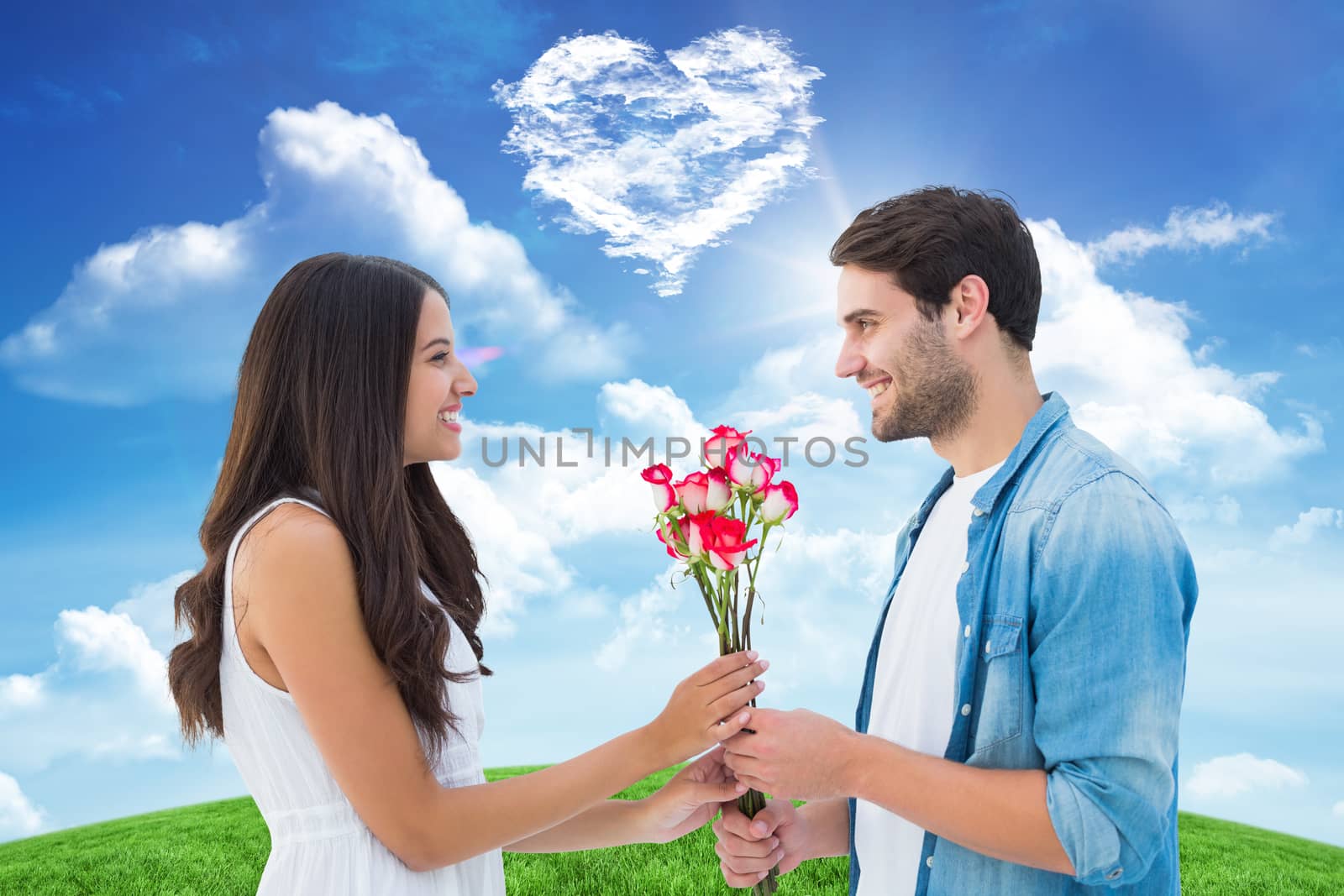 Happy hipster giving his girlfriend roses against cloud heart