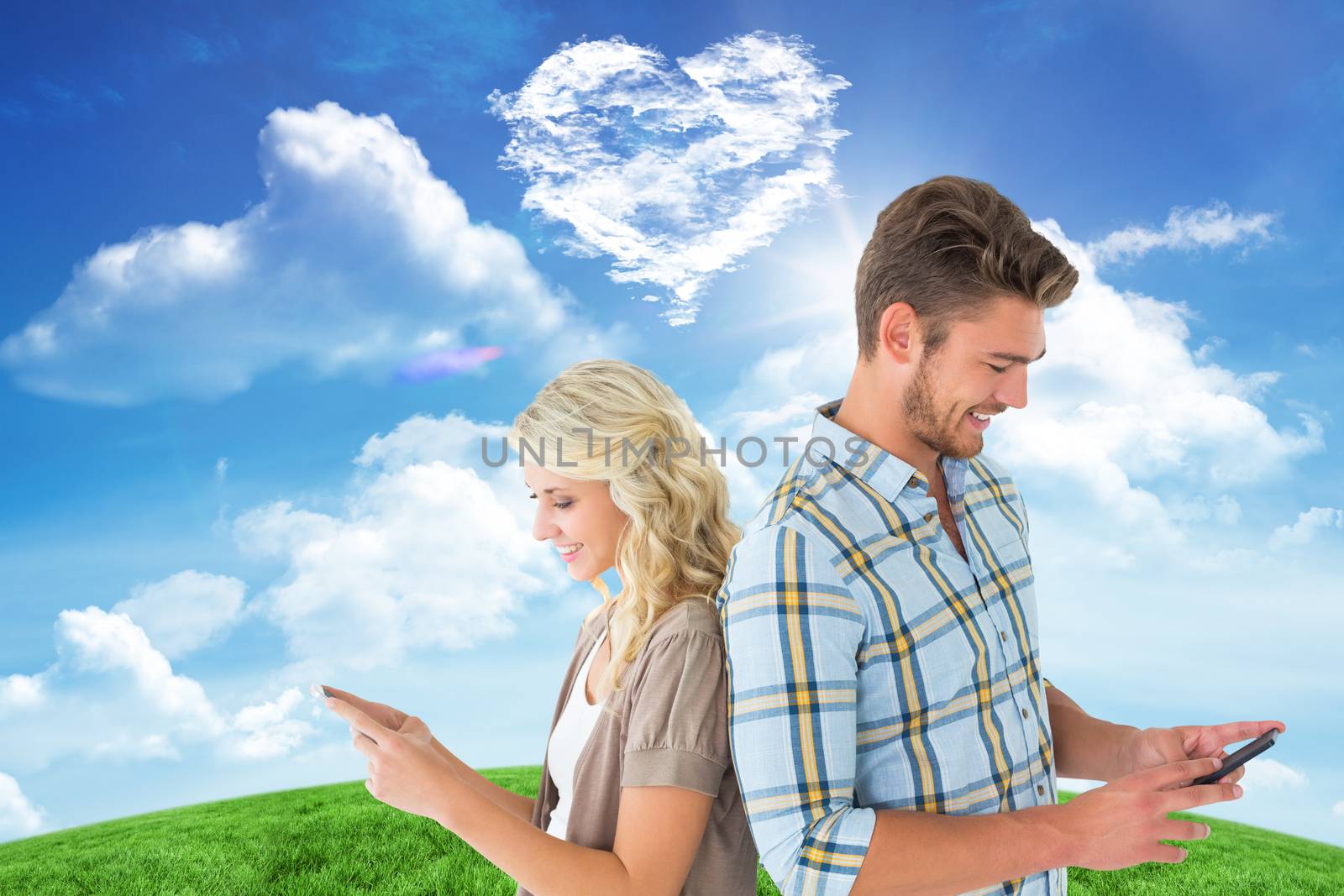 Attractive couple using their smartphones against cloud heart