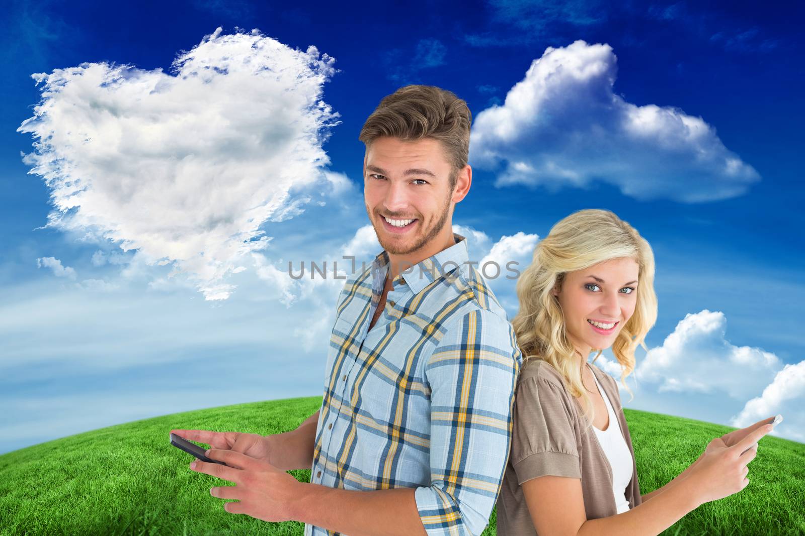 Attractive couple using their smartphones against cloud heart