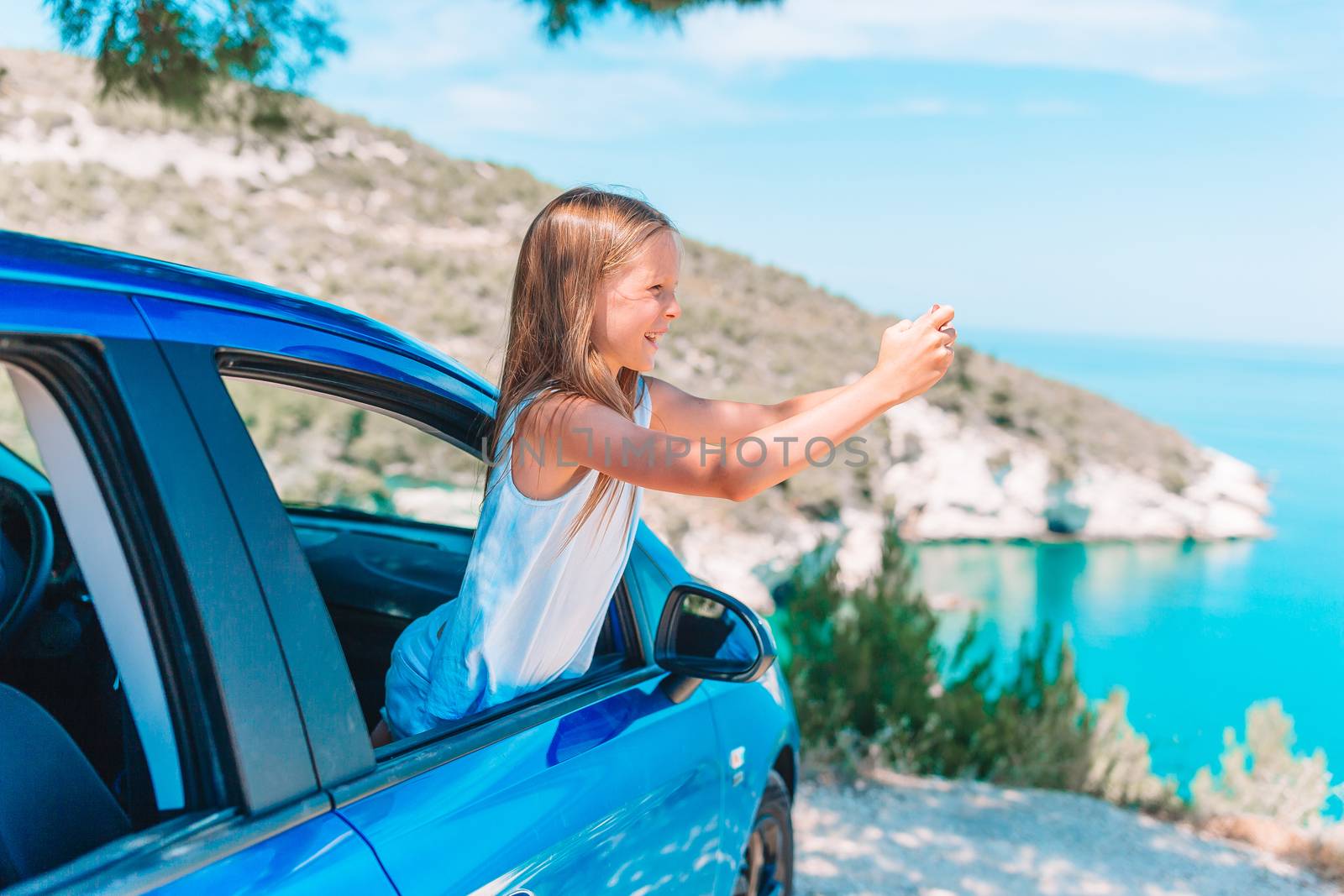 Little girl on vacation travel by car. Summer holiday and car travel concept by travnikovstudio
