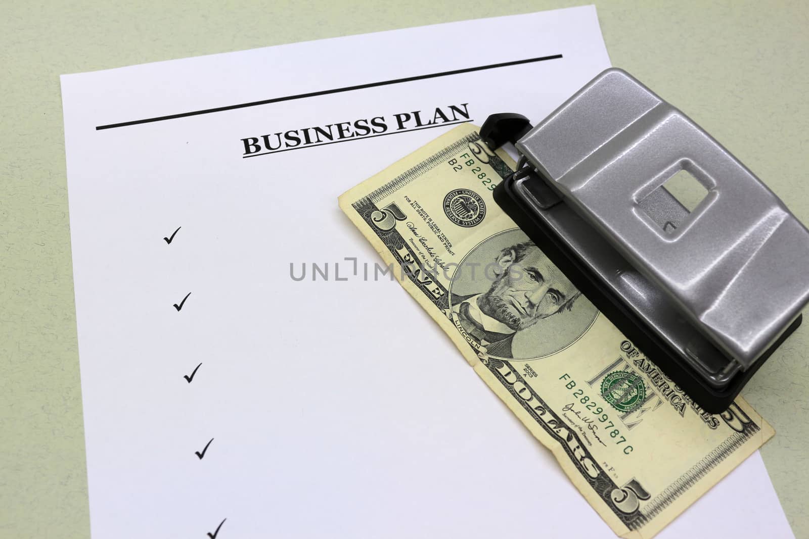 Money, documents, business plan and office punch