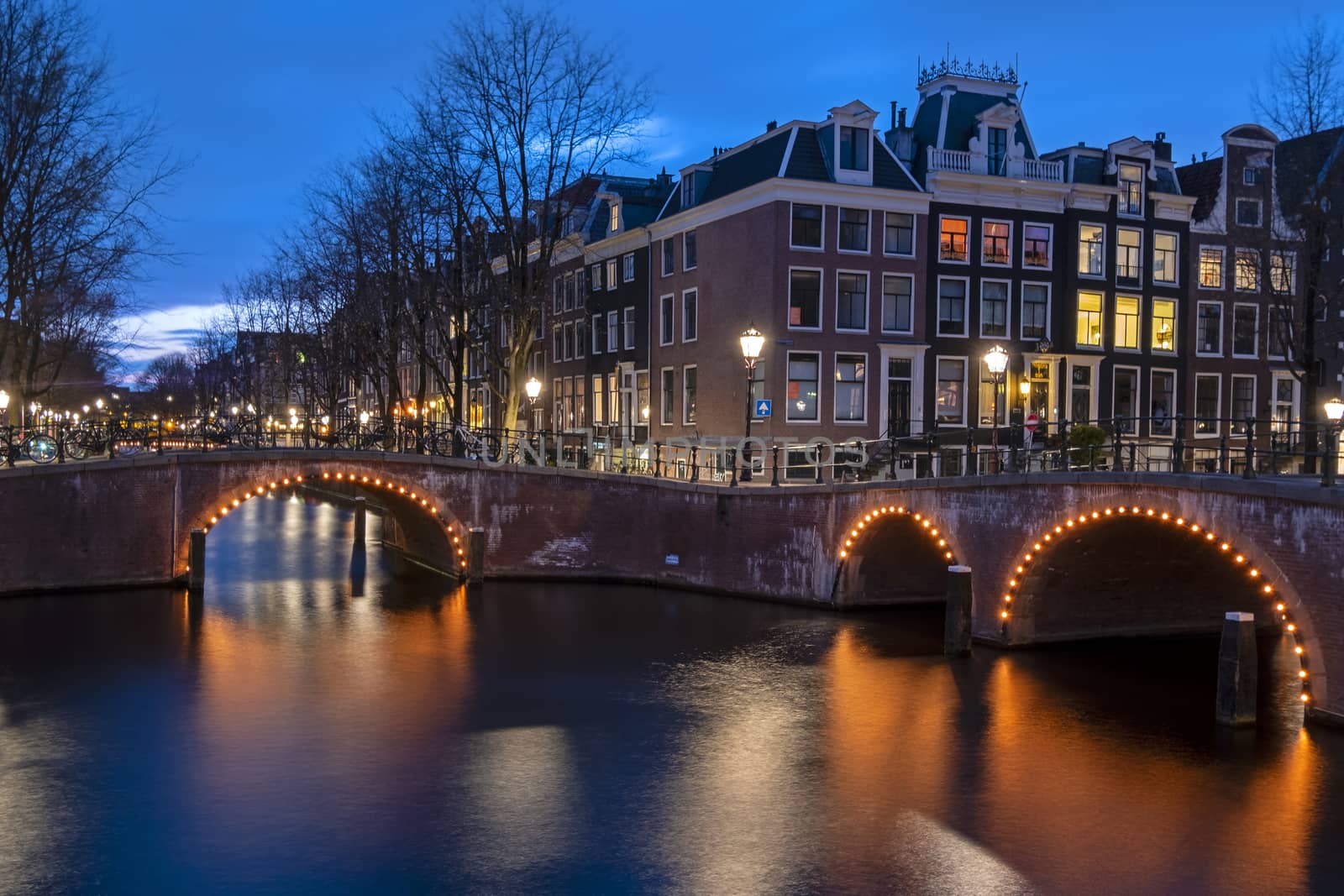 City scenic from Amsterdam at the canals in the Netherlands at night