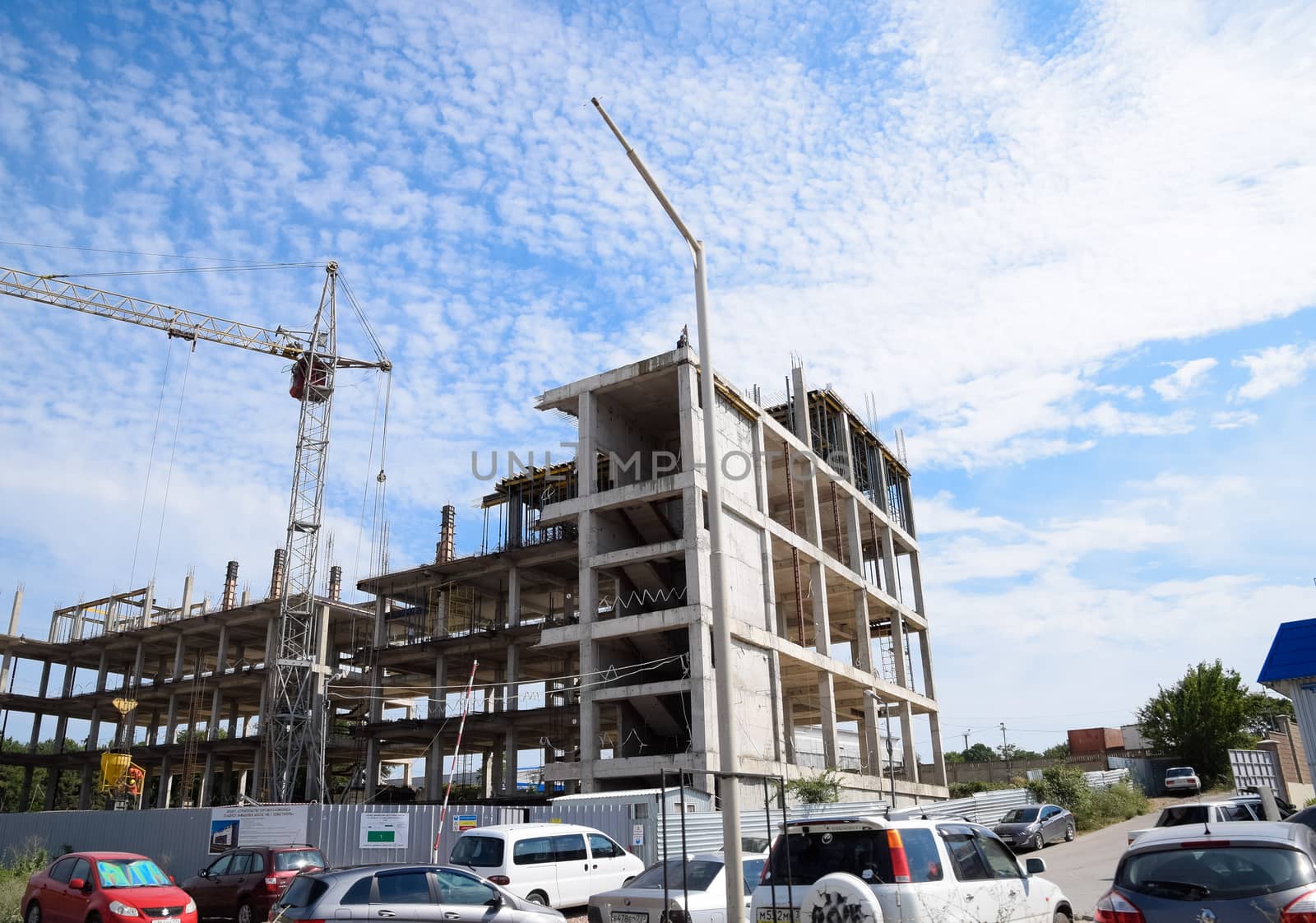 construction of multi-storey residential buildings. Tower cranes at a construction site.