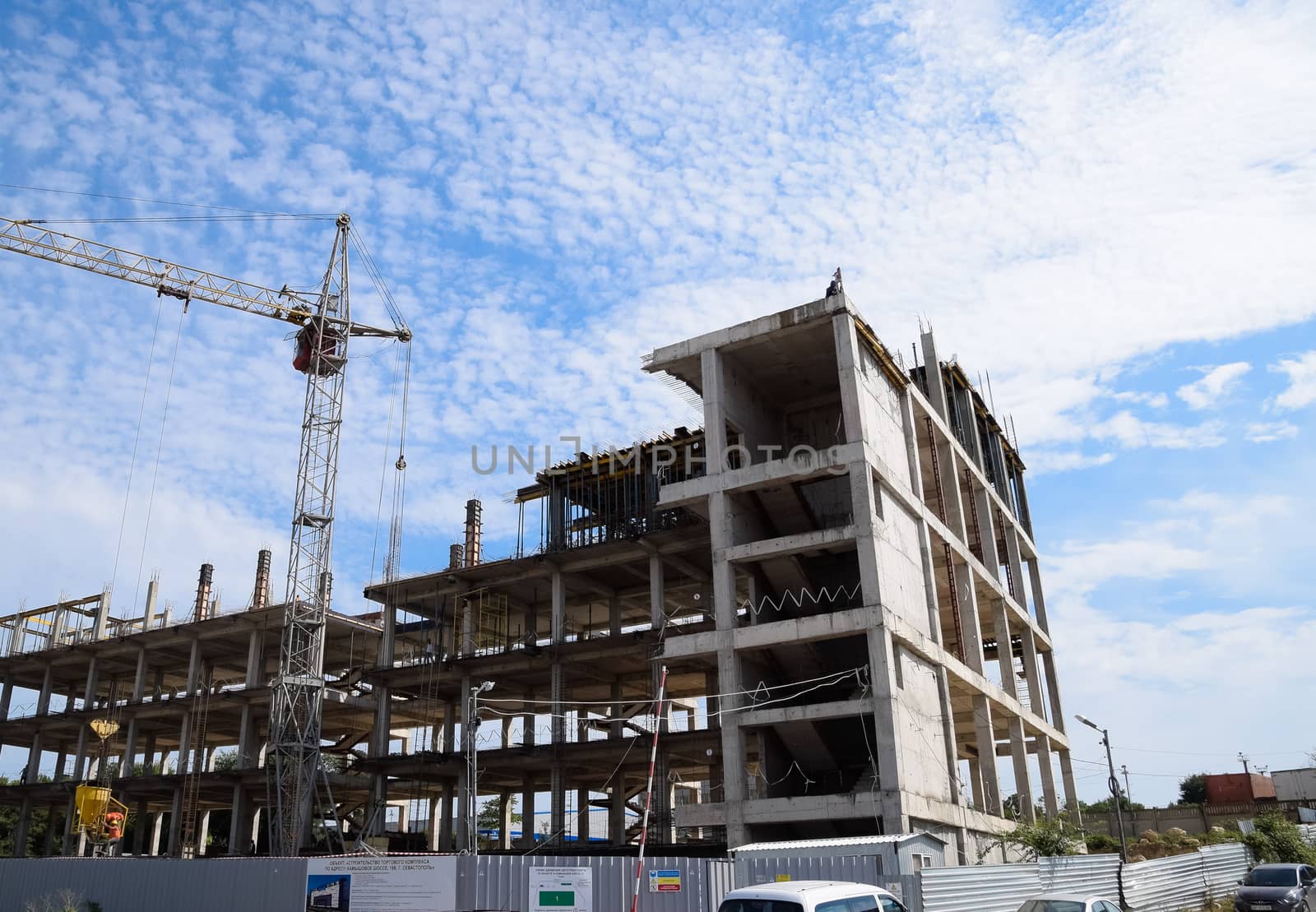 construction of multi-storey residential buildings. Tower cranes at a construction site.