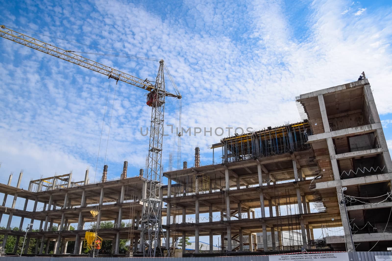 construction of multi-storey residential buildings. Tower cranes at a construction site.