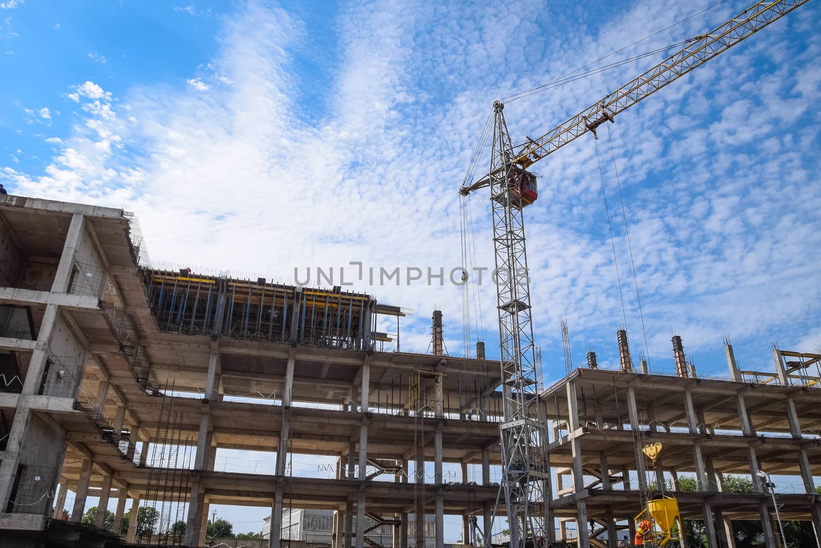 construction of multi-storey residential buildings. Tower cranes at a construction site.