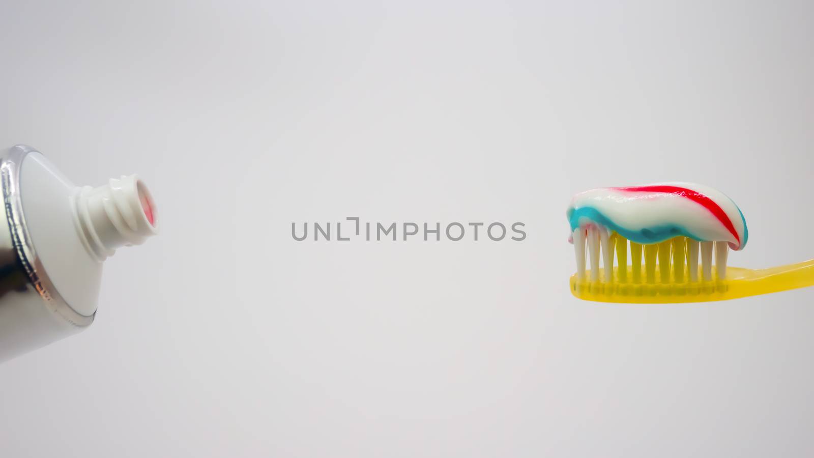 toothbrush with toothpaste on a white background