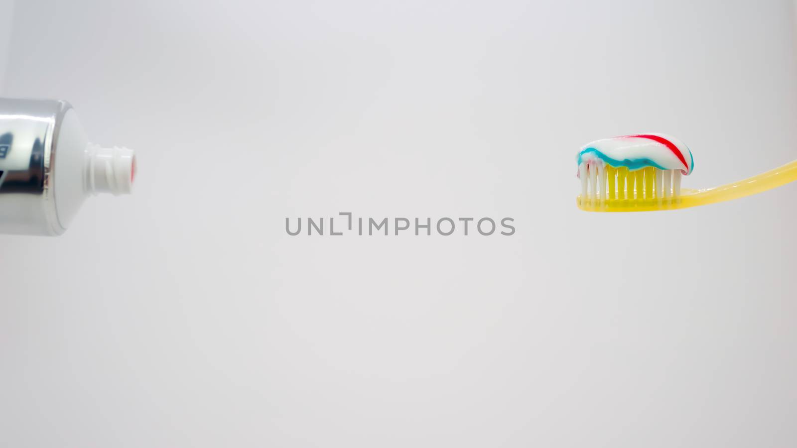 yellow toothbrush with toothpaste on it