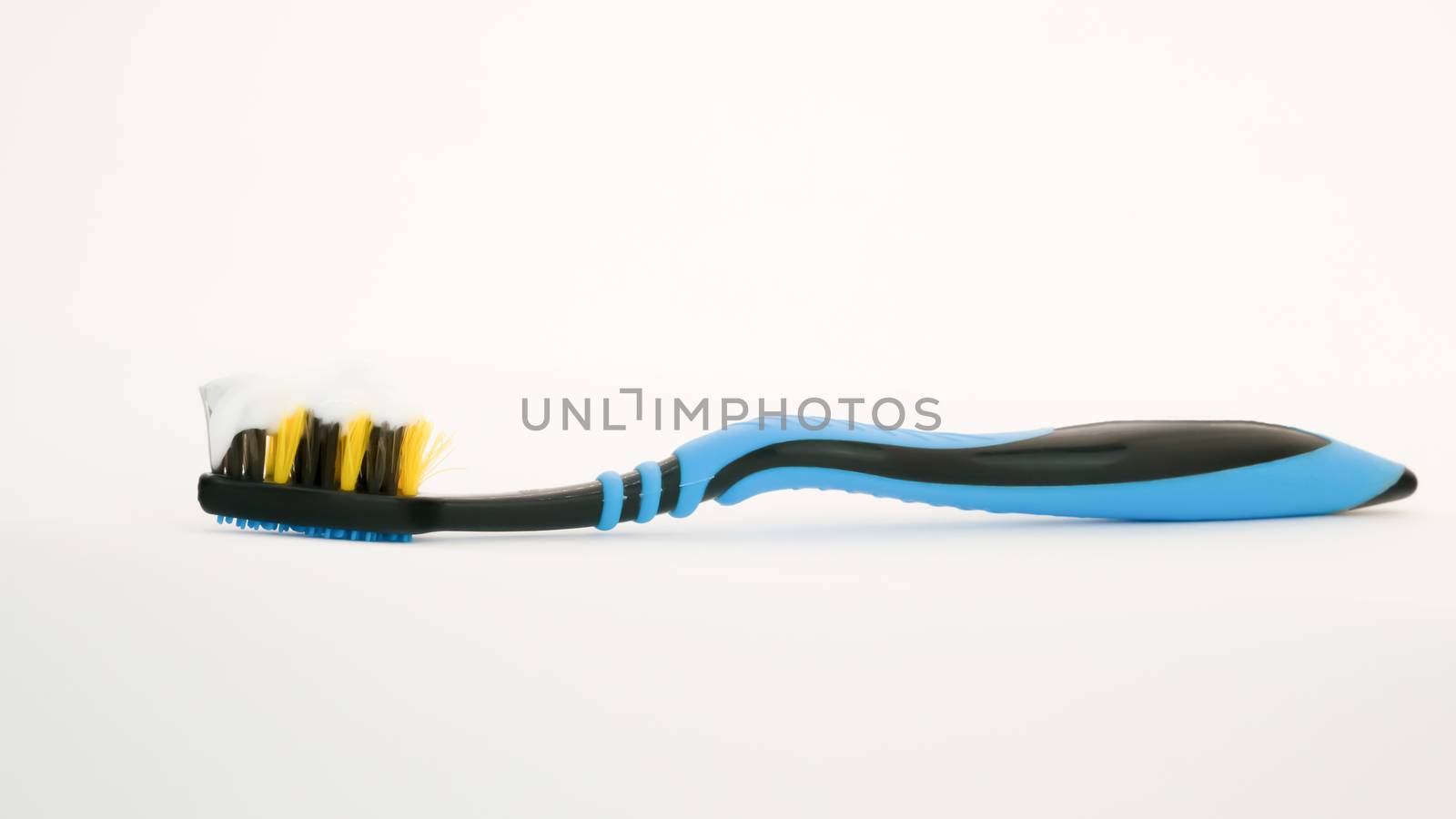 Toothbrush with villi paste on white background