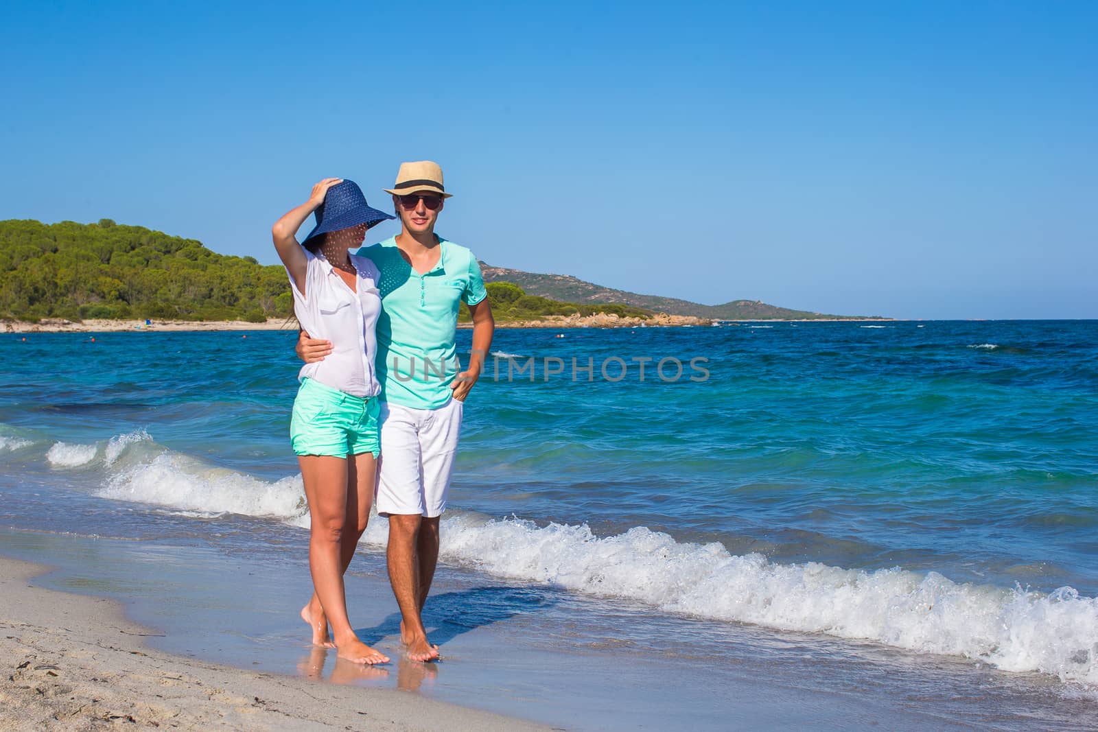 Romantic couple at tropical beach during summer vacation by travnikovstudio